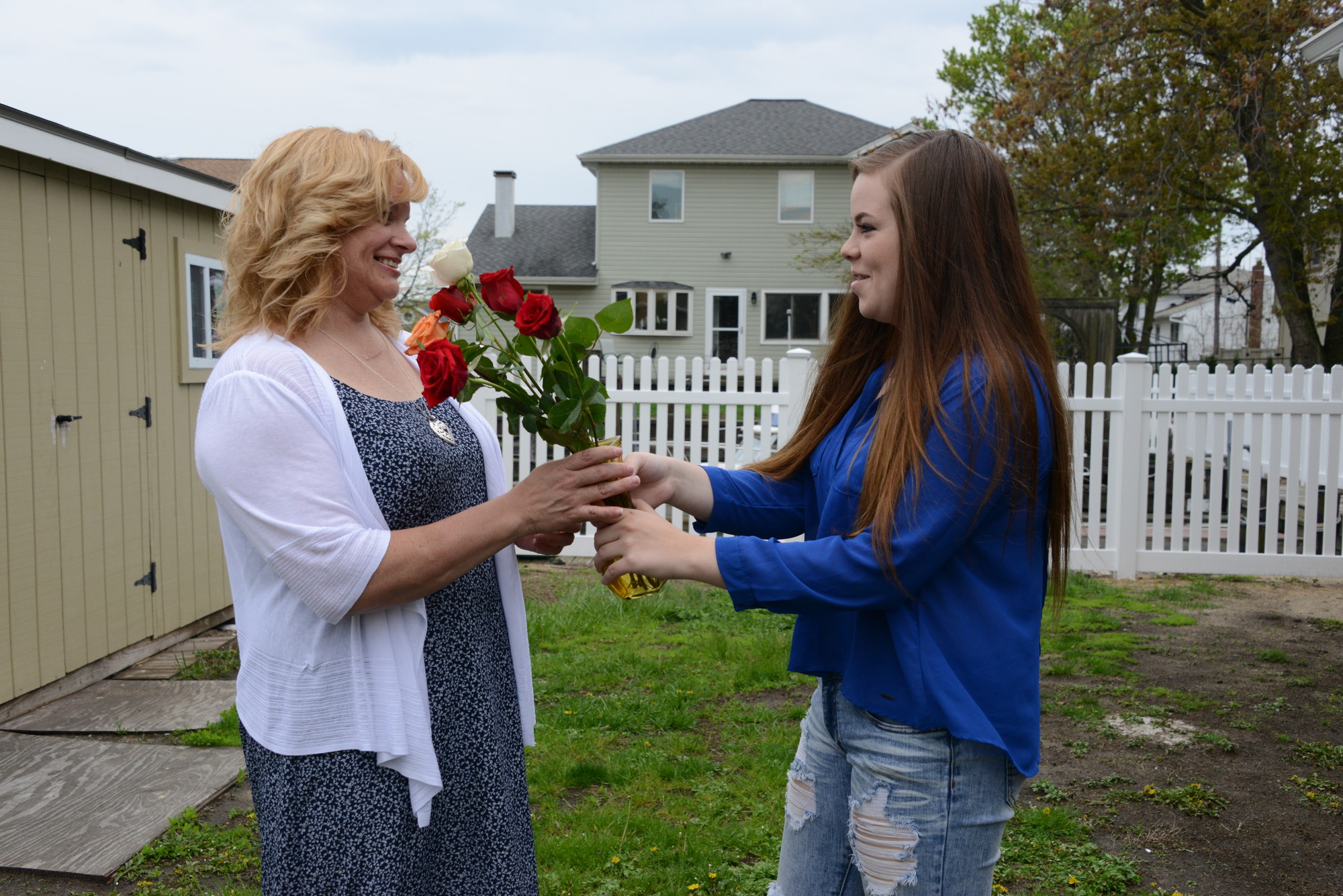 Katie Swanson, right, gave her mother, Vickie, some roses outside South Nassau Christian Church on May 10.