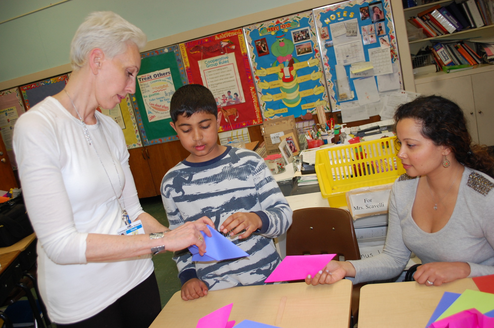 Instructor Leah Bernstein helped Daniel Amin, a fourth-grader at the Willow Road School, and his mother, Savita, with their origami project at District 13’s Explorations Day on May 5.