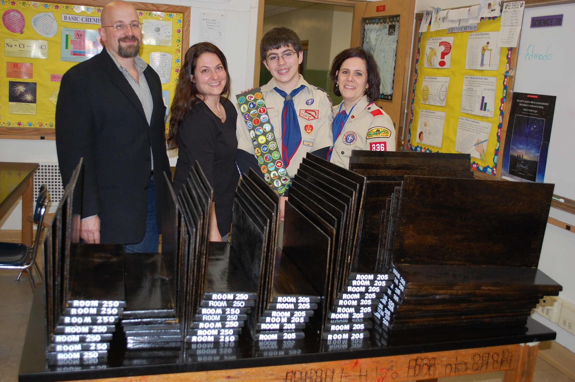 Steven Santiago, second from right, made test dividers that Memorial Junior High science teachers Angelo Stanco, Roni Franabia-Kropf and Elsie Santiago will use in their classrooms.