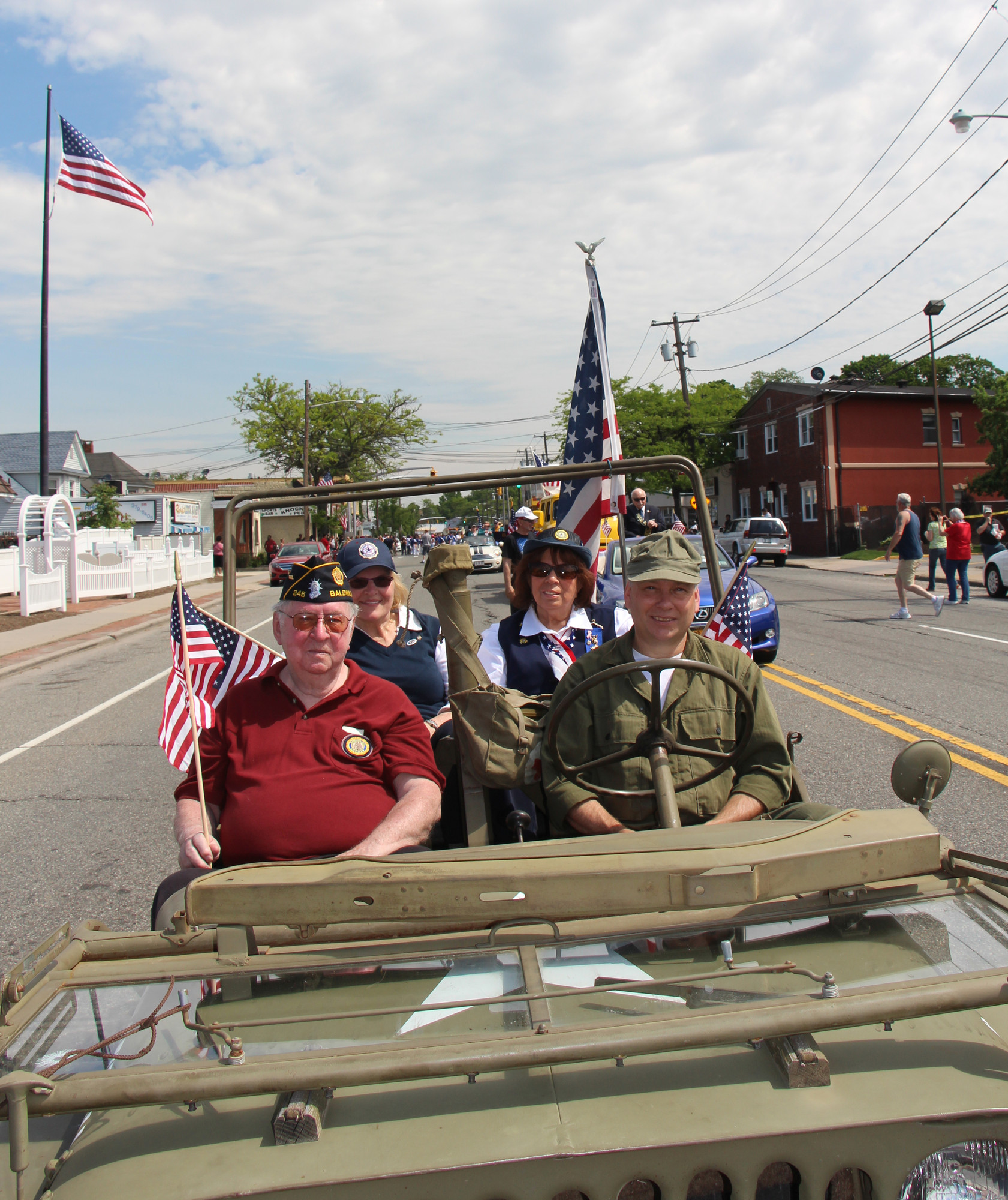 Veterans carried American flags during their marches and rides down Grand Avenue on May 26 during the Memorial Day Parade.