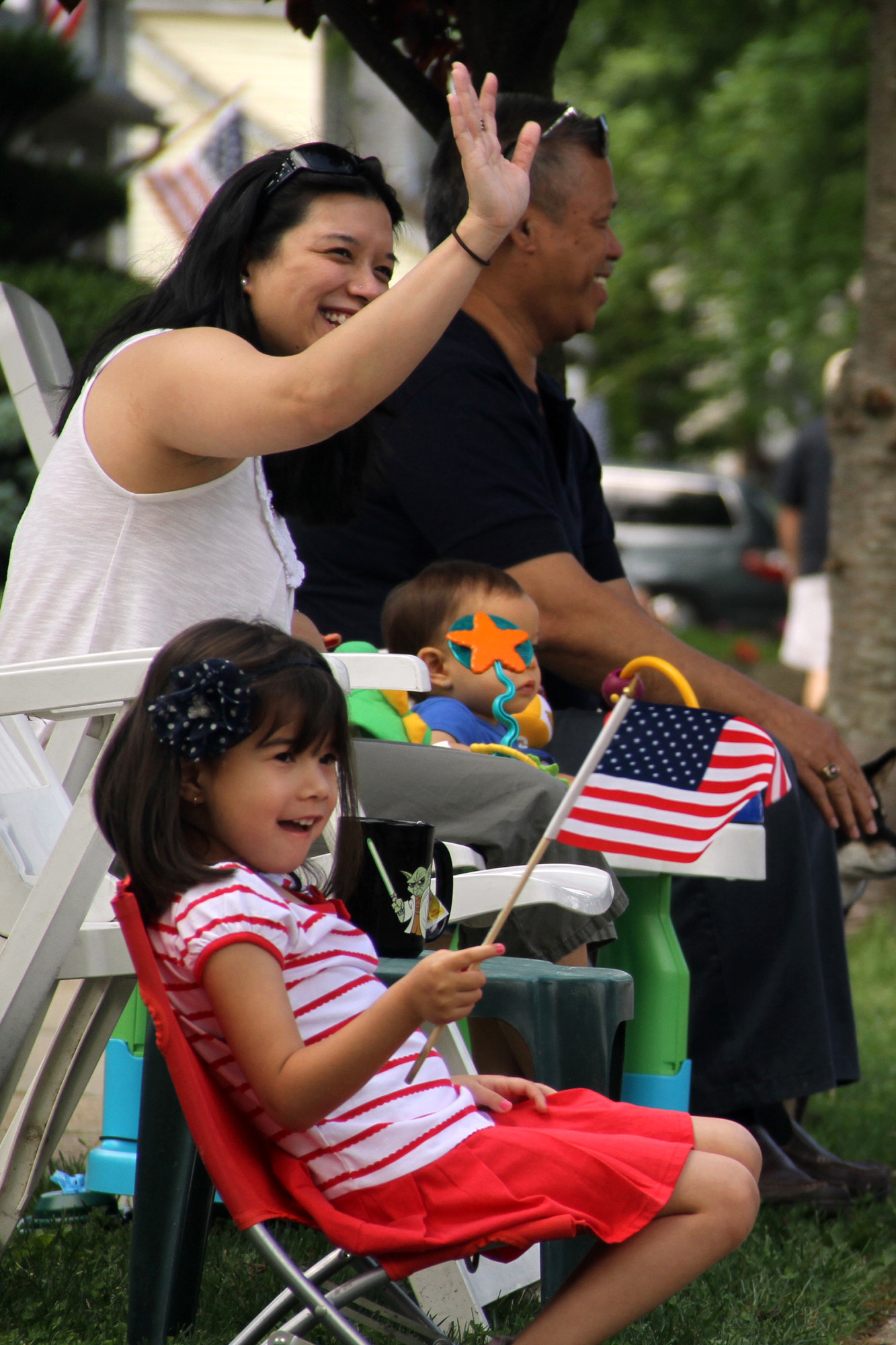 Aileen Bjelland and her family wave to veterans as the pass during the Malverne parade.