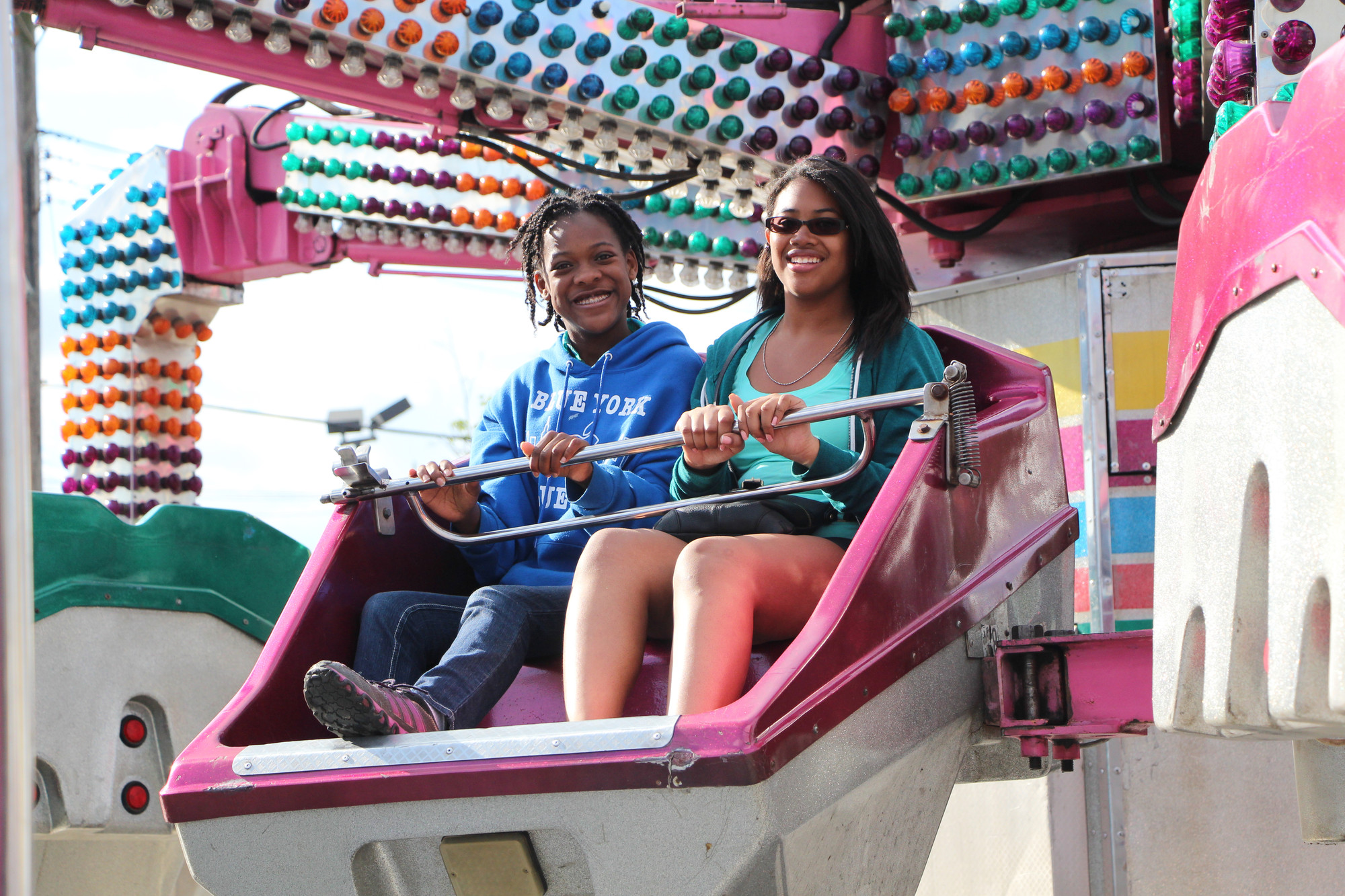 Mia Jean-Louis, 14, left, and Joelle Nicolas, 14, took a ride on the Twister last weekend under sunny skies.