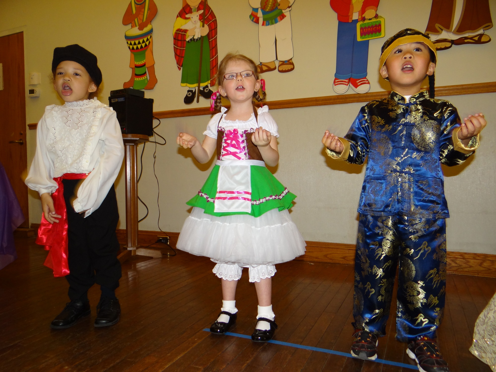 Jovan Brafman, 4, left, represented Russia, Scarlett Demmerle, 4 took on the role of Gemany, and AJ Velasco, 4, represented Japan.