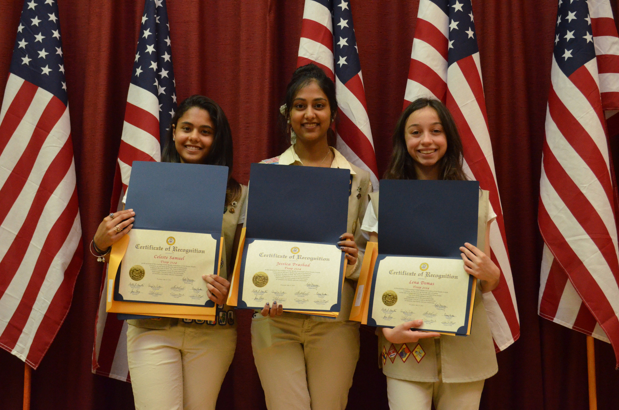 Troop 2124 Girl Scouts, from left, Celeste Samuel, Jessica Prashad and Lena Demas received certificates in recognition of their scouting achievements at a ceremony on May 23.