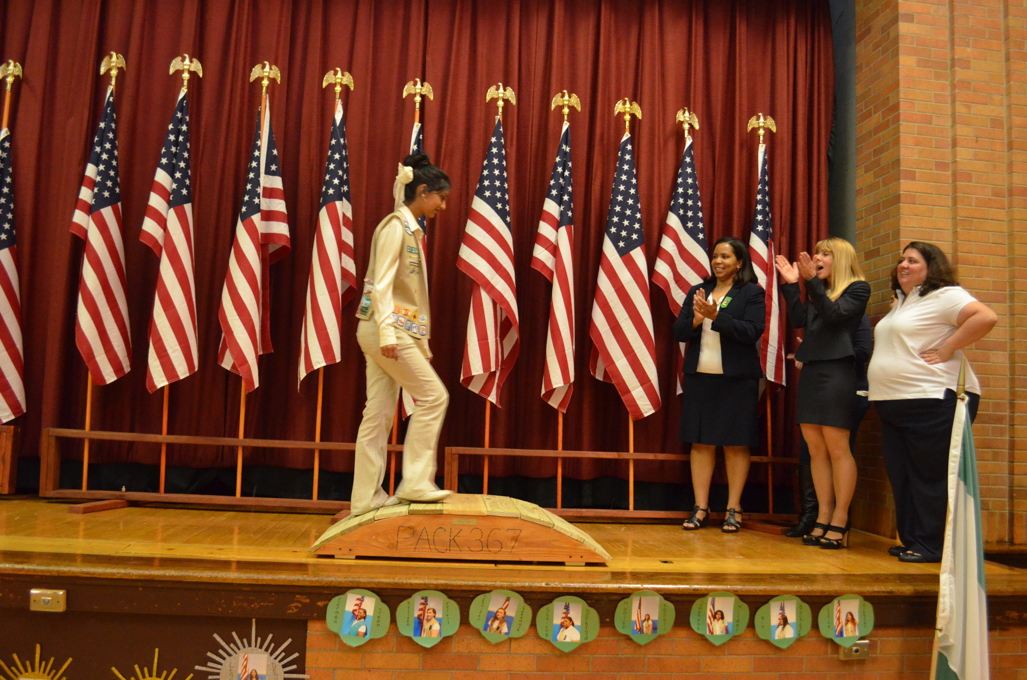 Jessica Prashad crossed the bridge from Ambassador to Adult Volunteer, one of 20 Girl Scouts to earn a rank advancement at the ceremony.