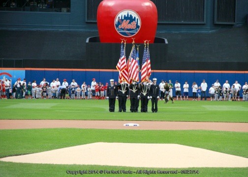 The Lynbrook Fire Department’s Color Guard presented the flag during the singing of the National Anthem, while little leaguers and coaches lined up on the warning track between the foul poles.