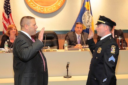 Police Commissioner Charles Gennario, left, administered the oath of office to new sergeant John Beatty on June 2.