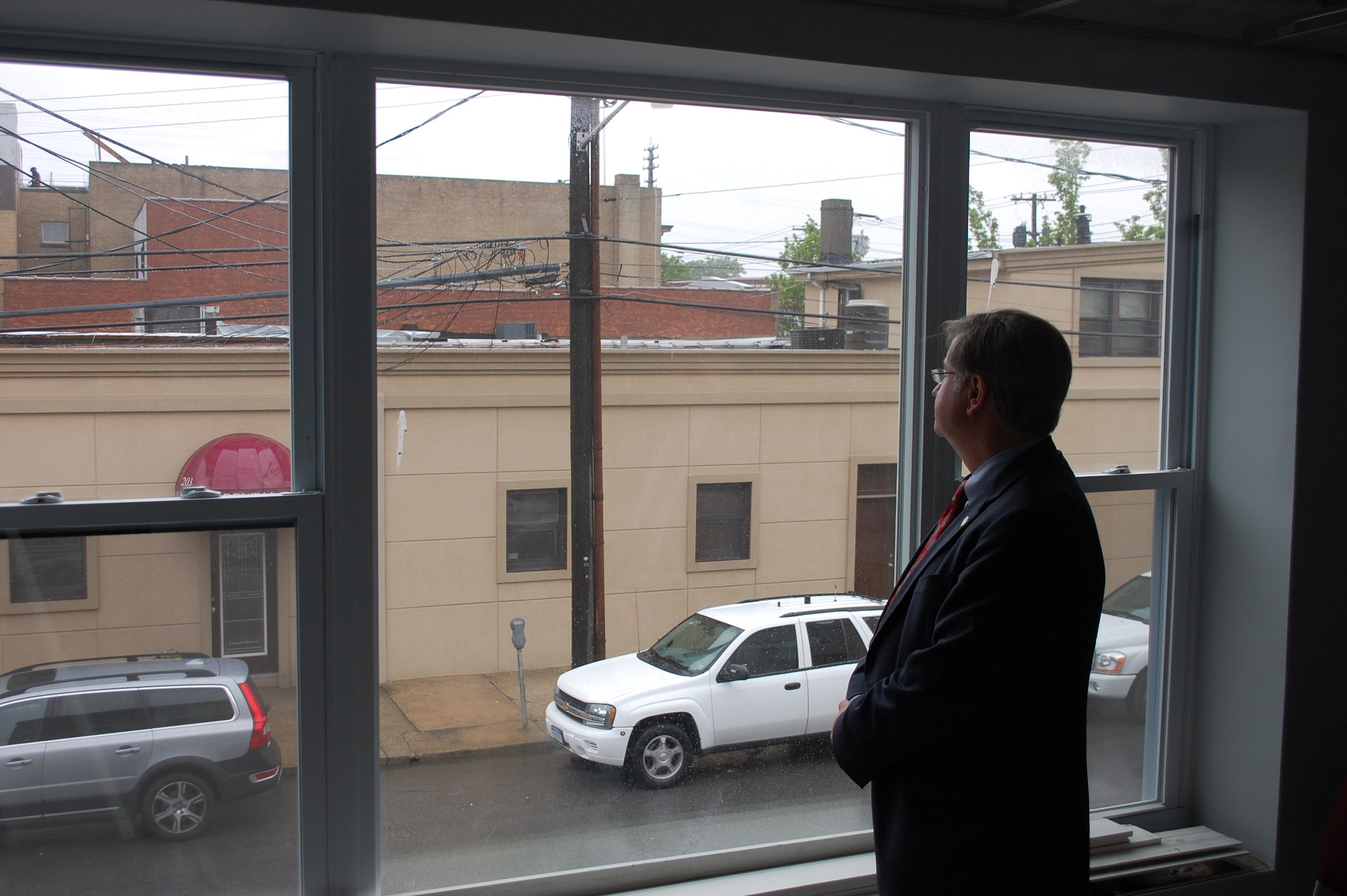 Village Justice Robert Bogle looks out the window from his future office at 195 Rockaway Ave.