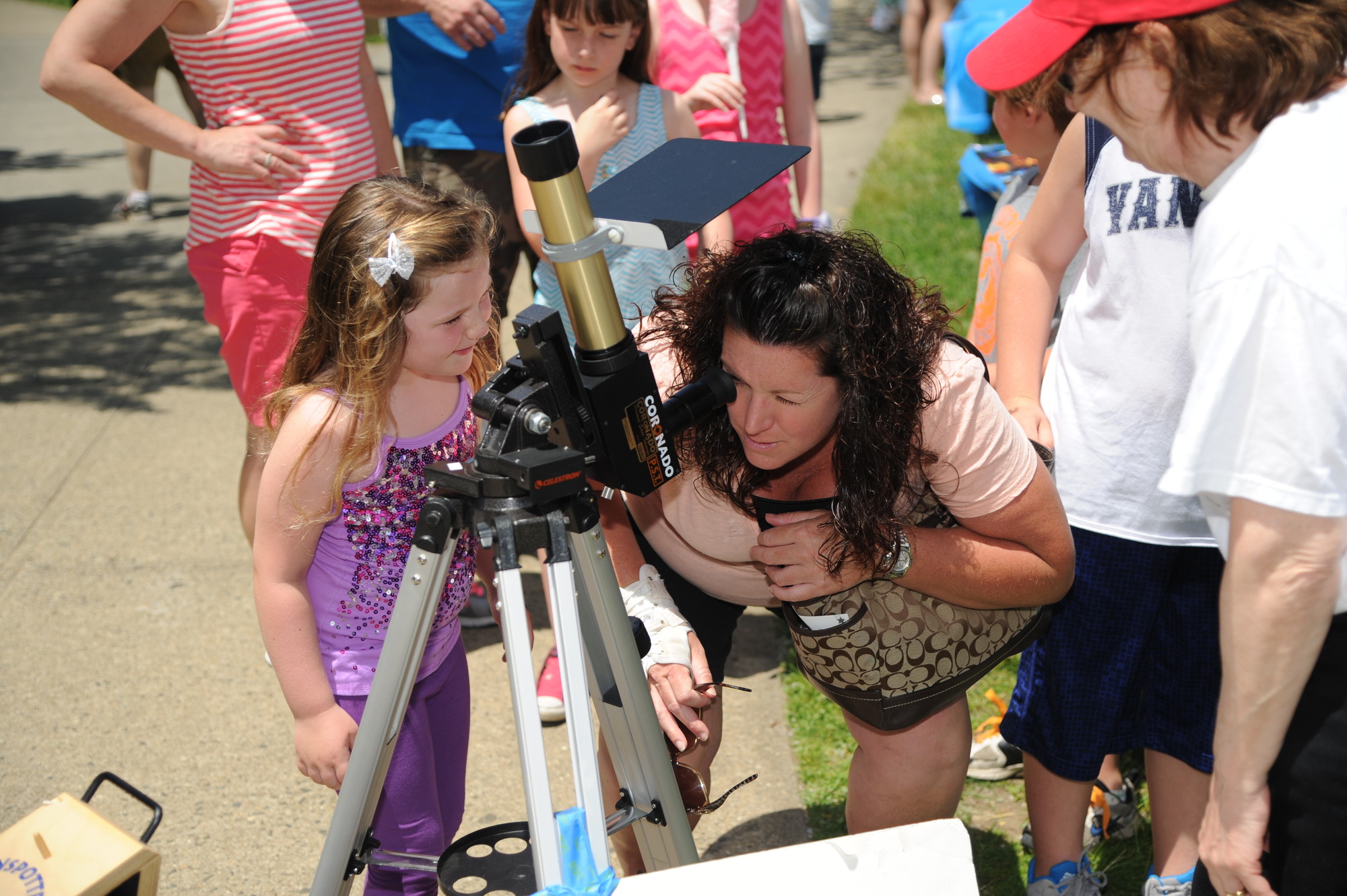 Ashley O’ Connor, 4, waited her turn as her mother, Lisa, used a telescope to peer into the sky above.