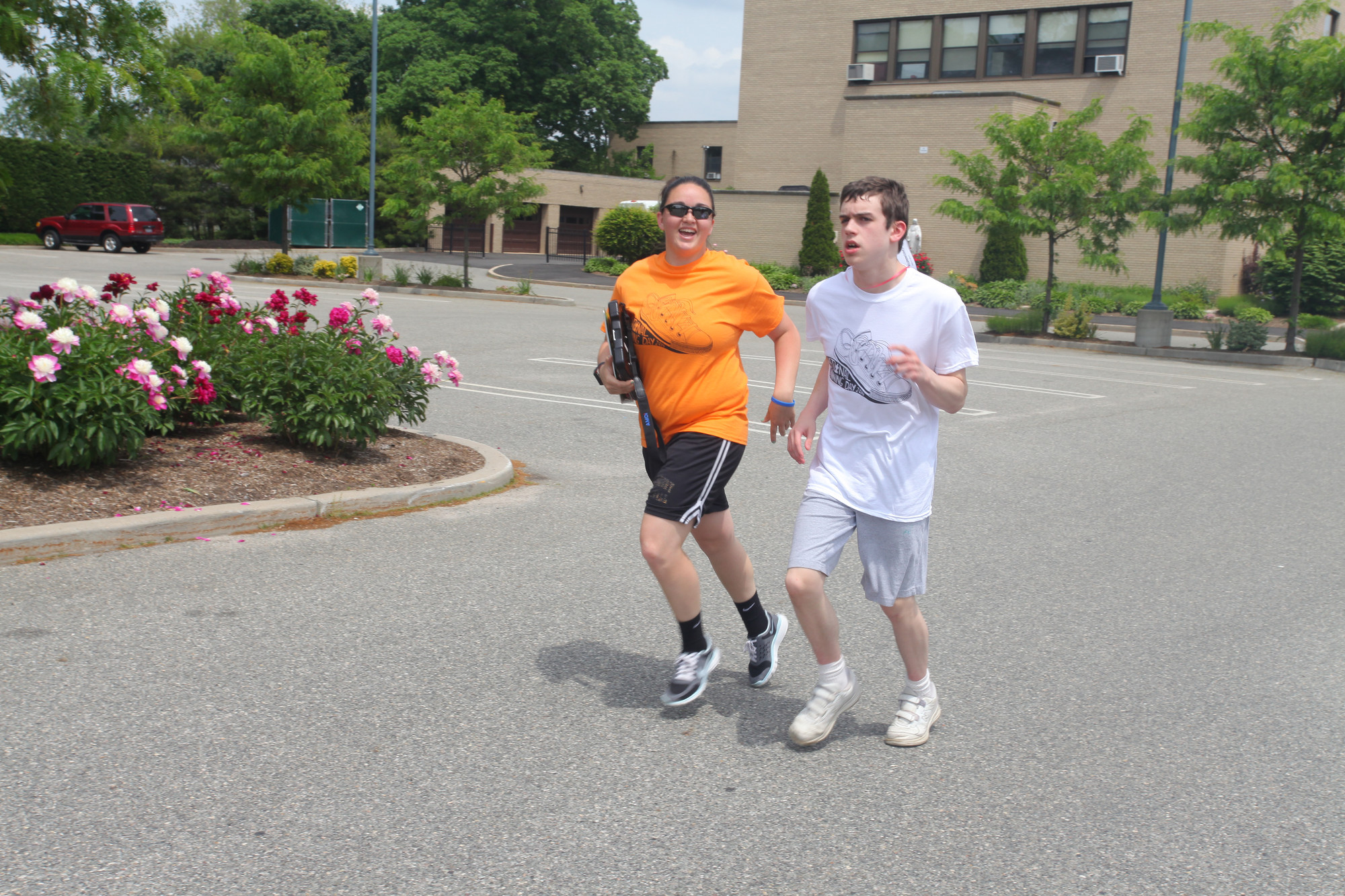 Phys.-ed.- teacher Meaghan Ogara jogged with student Brian.