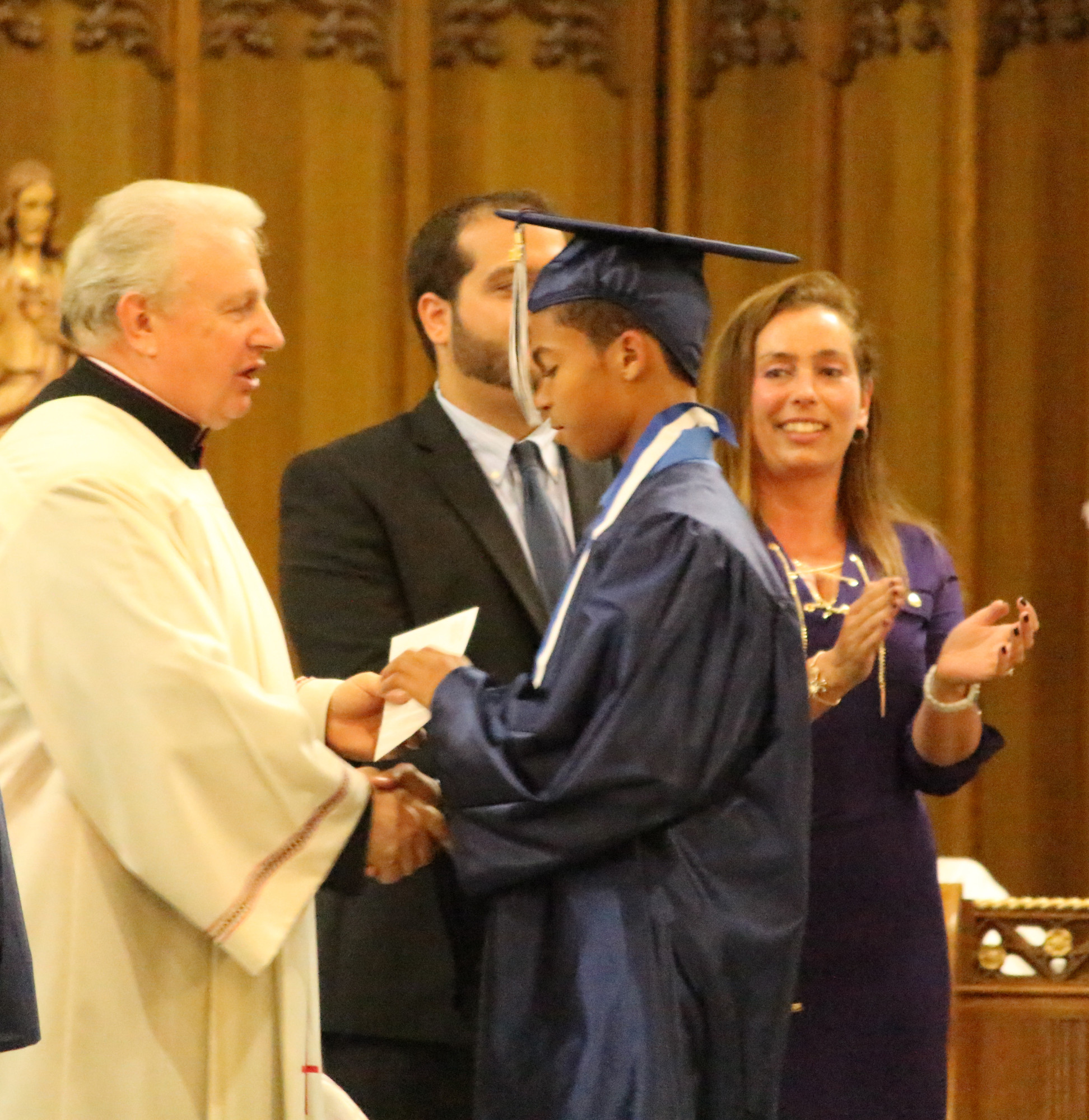 Rev. Msgr Steven Camp congratulated Tyler Walker on his achivement.