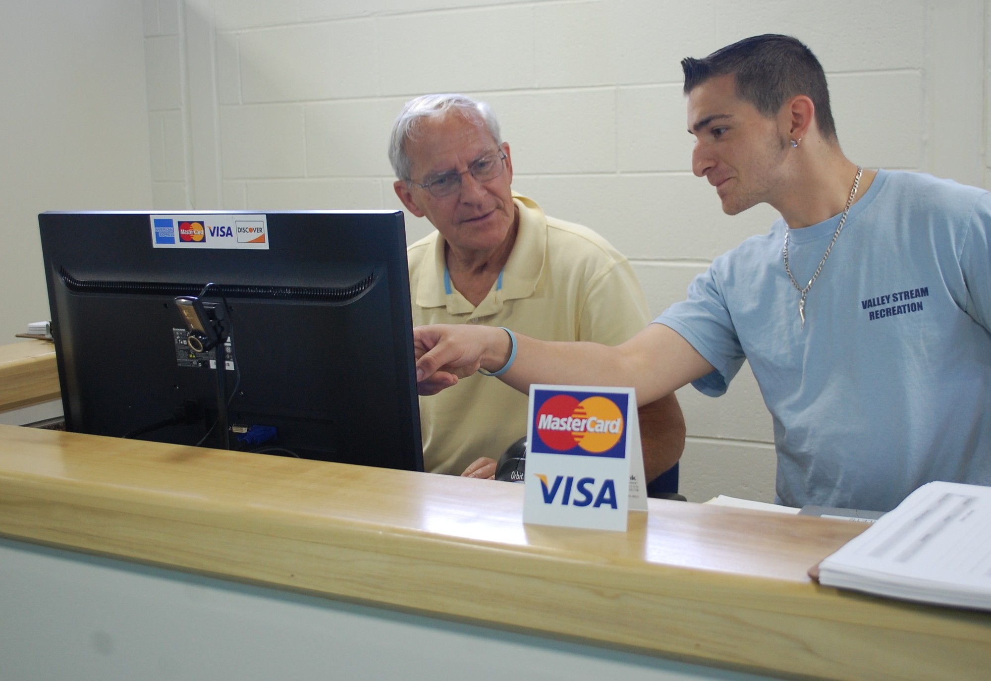 Recreation Director Tom Roberts and attendant Vincent DePergola work at the new recreation counter in the pool complex.