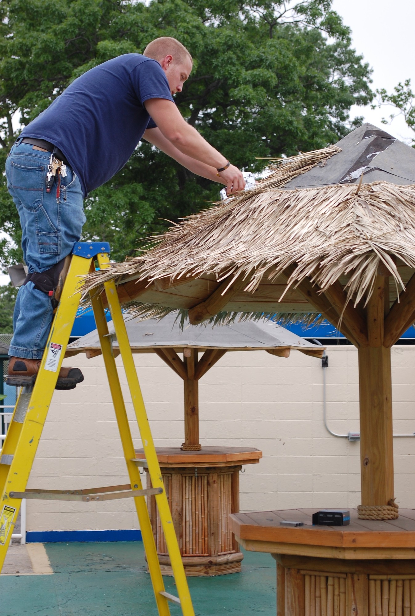 Chris Sottile got the tiki huts ready for the 2014 pool season.