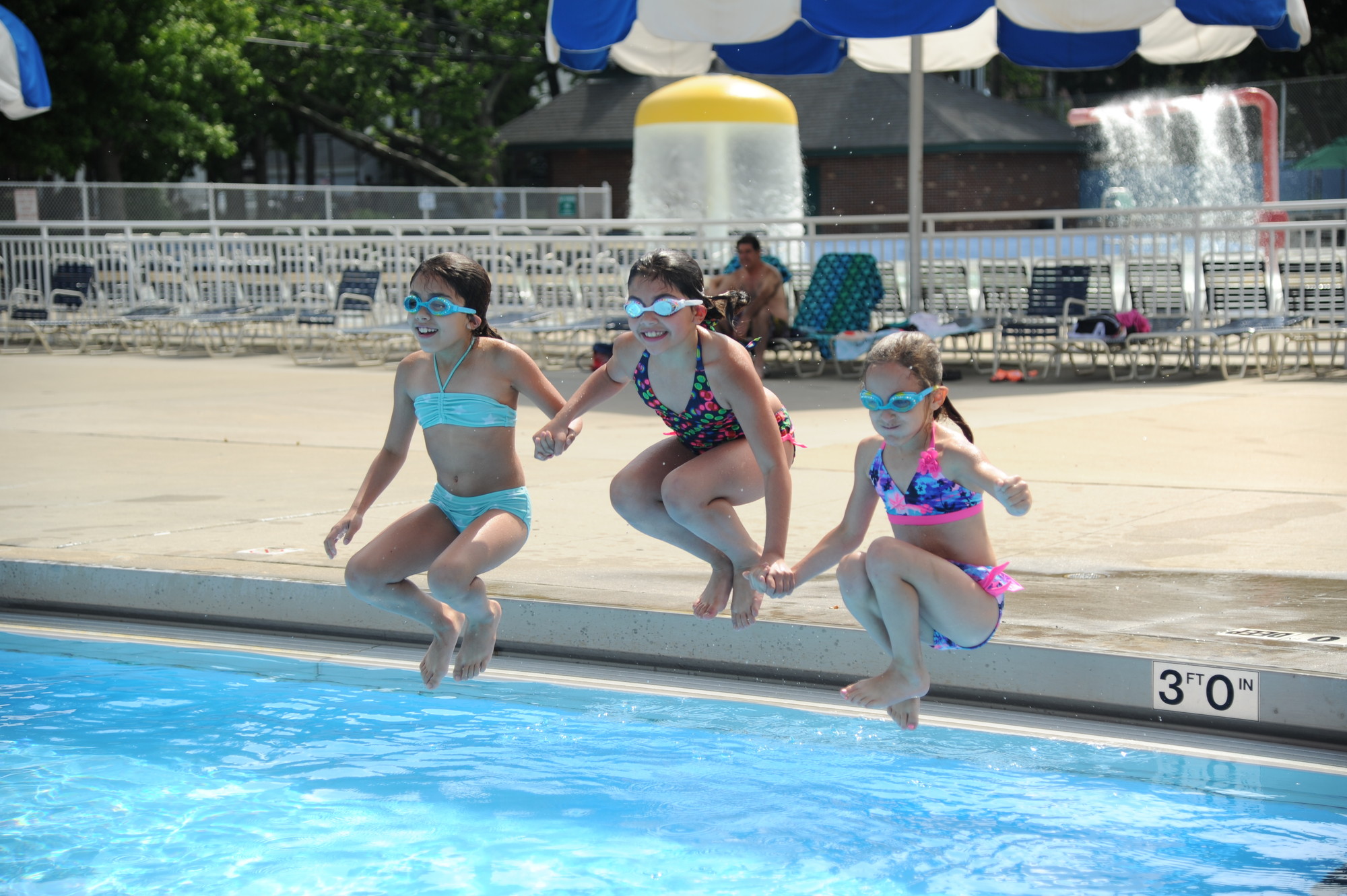 Isabella Pichardo, 9, left, Olivia Pichardo, 7, and Alexandra Marsella, 8, were among the first swimmers of the season at the Valley Stream pool, which opened Saturday morning.