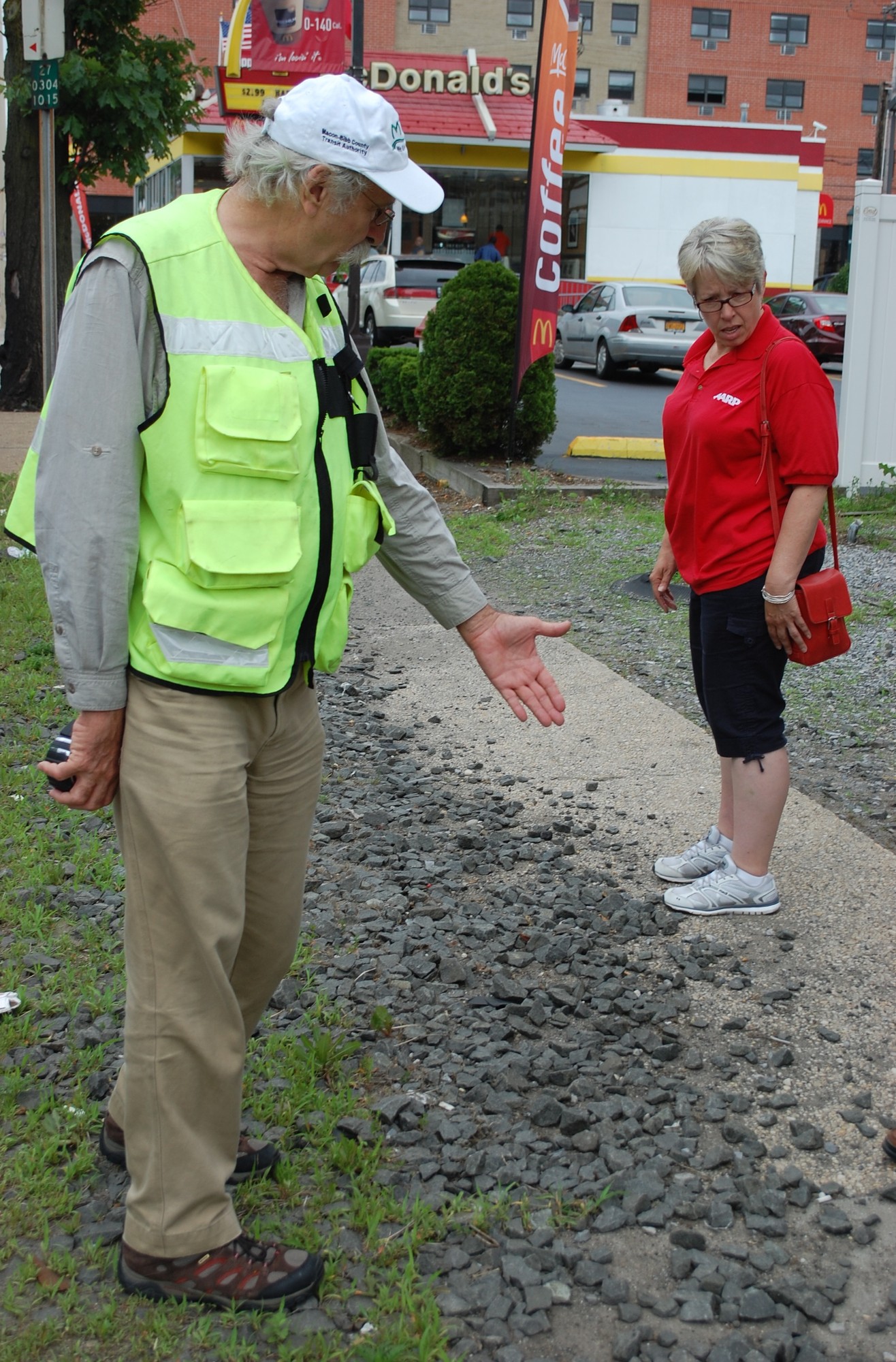 Dan Burden pointed to a patch of rocks covering the sidewalk as an obstacle to pedestrians.