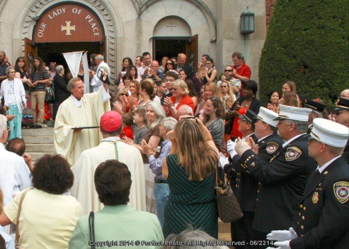 Monsignor Bill Breslawski was greeted outside church by dozens of well-wishers.