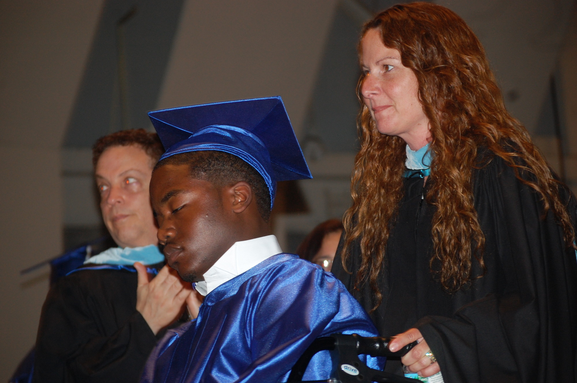 Jurell WIlson was helped by guidance counselor Kathy Hardy to receive his diploma on June 25.