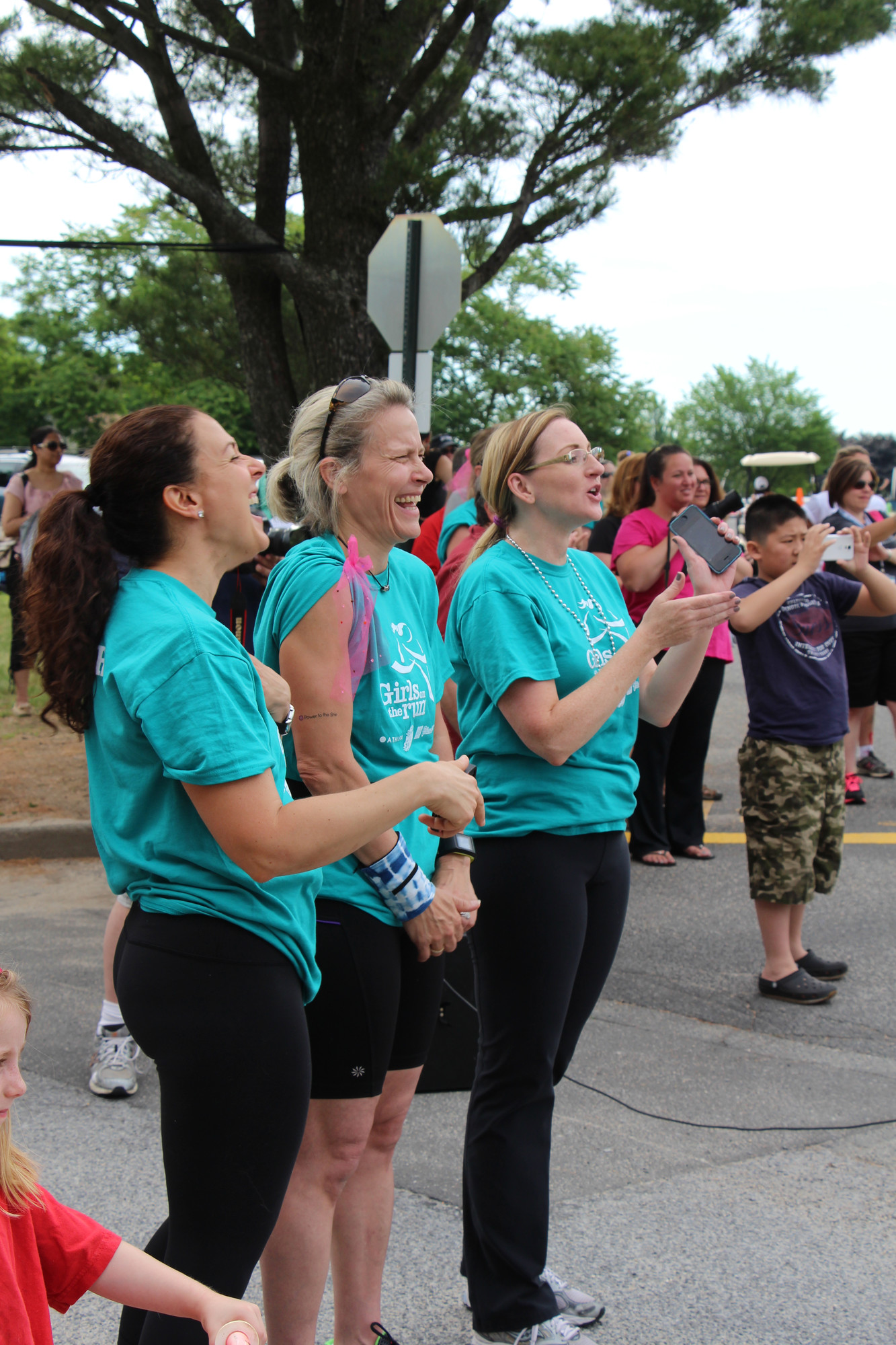 Coaches cheered from the sidelines: KIristina Constantino, Diane Dobler, Kristine Hackett applauded as the girls make their way in to the finish line.