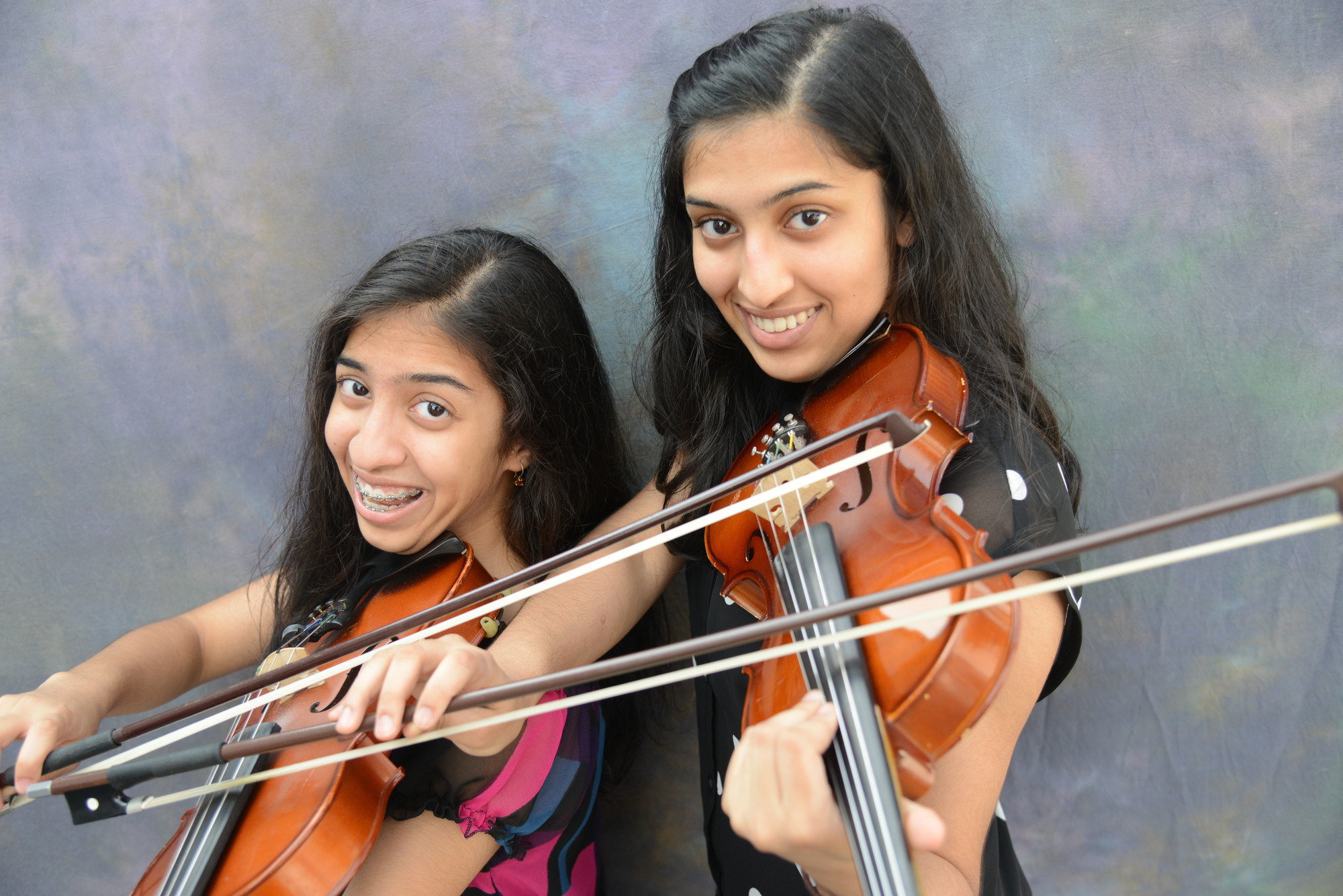 Aashini Shah, 13, and sister Binita, 17, of Salisbury, are more than just violinists.