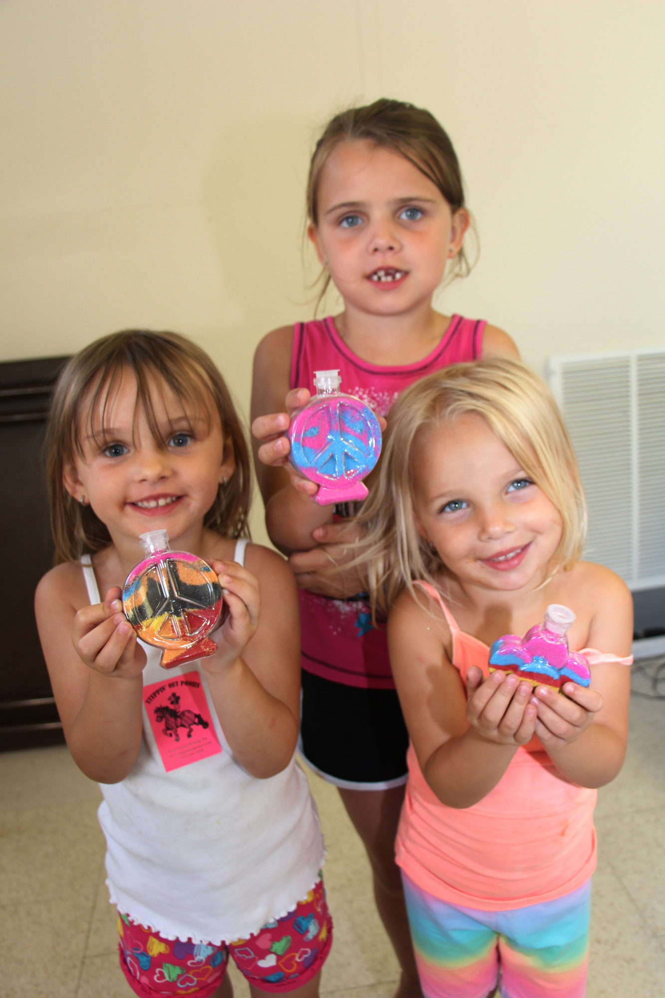 The Frantzen sisters had some fun making Sand art. Jaclyn, 3, left, Kylie, 3, right and Makayla, 6, showed off their work.