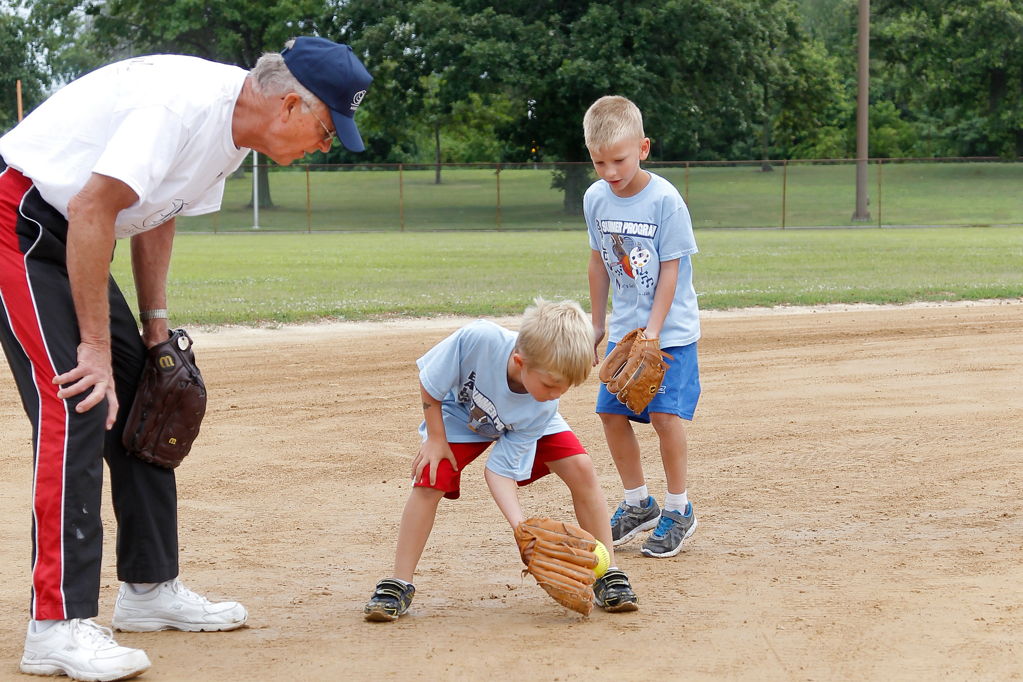 LISSA member Rod Ducasse, from Levittown, watched as  7-year-old Jacob Stevenson fielded a ground ball.