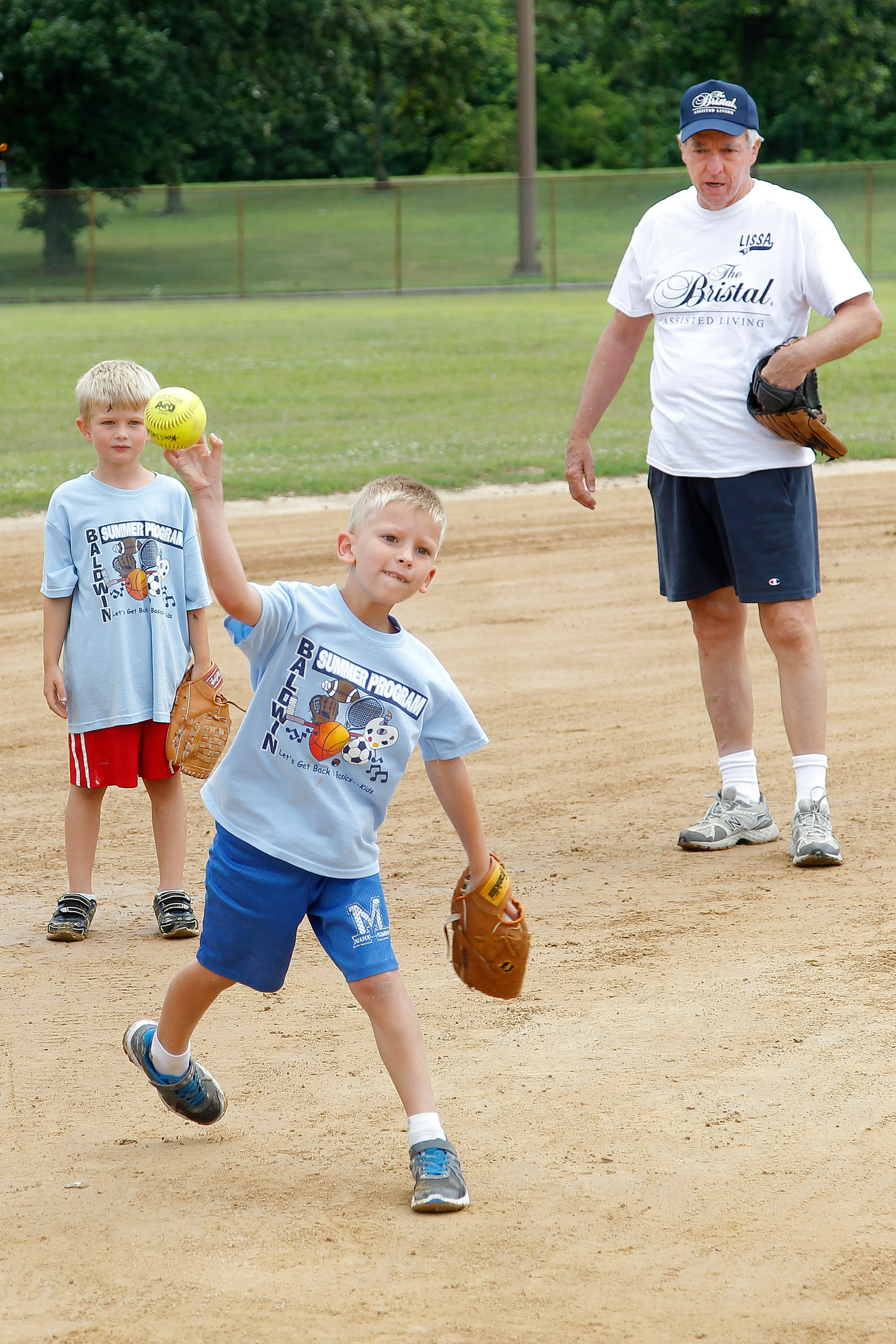 William Lomot, 6, center, practiced his throws from third base during a practice on July 16 at Baldwin Park with his teammate Jacob Stevenson, 7.