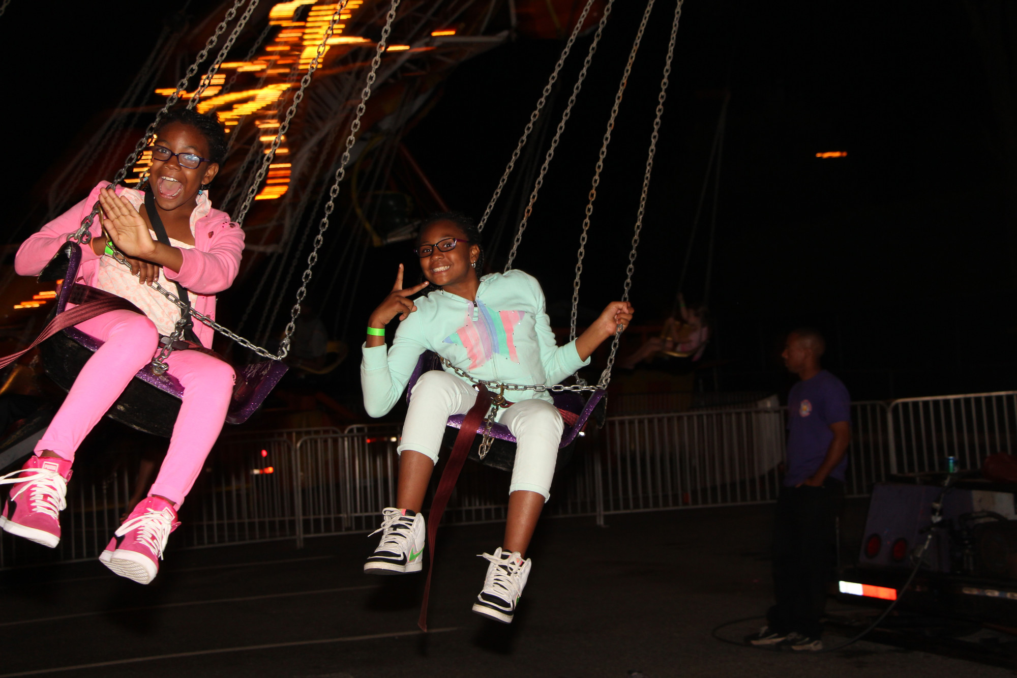 Madison, 10, left, and Selah Chambers, 8, took a spin on a swing ride at the St. Christopher’s Church Feast last weekend.