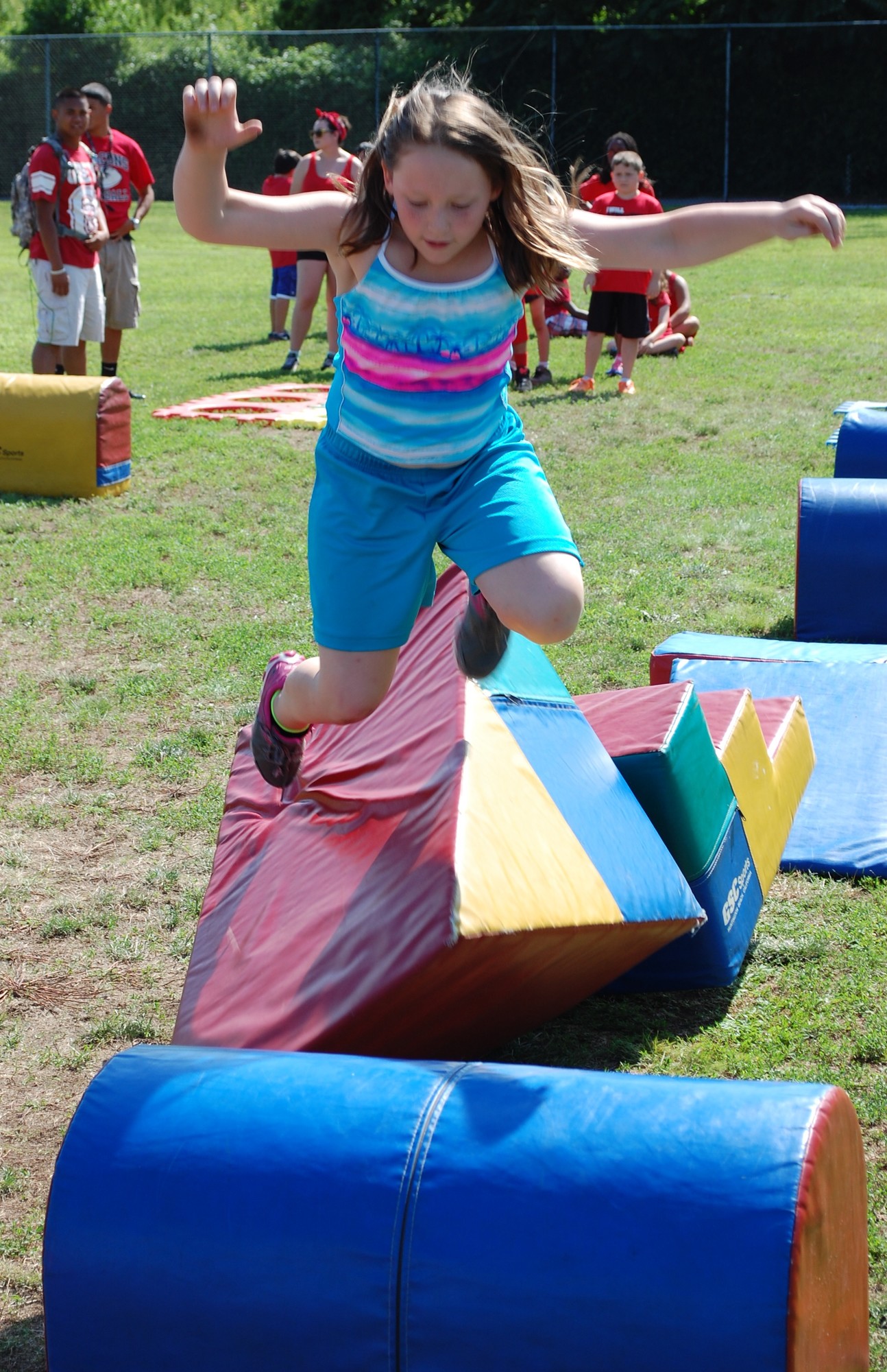 Alexandra Bartolomeo tries to clear a hurdle in the obstacle course.