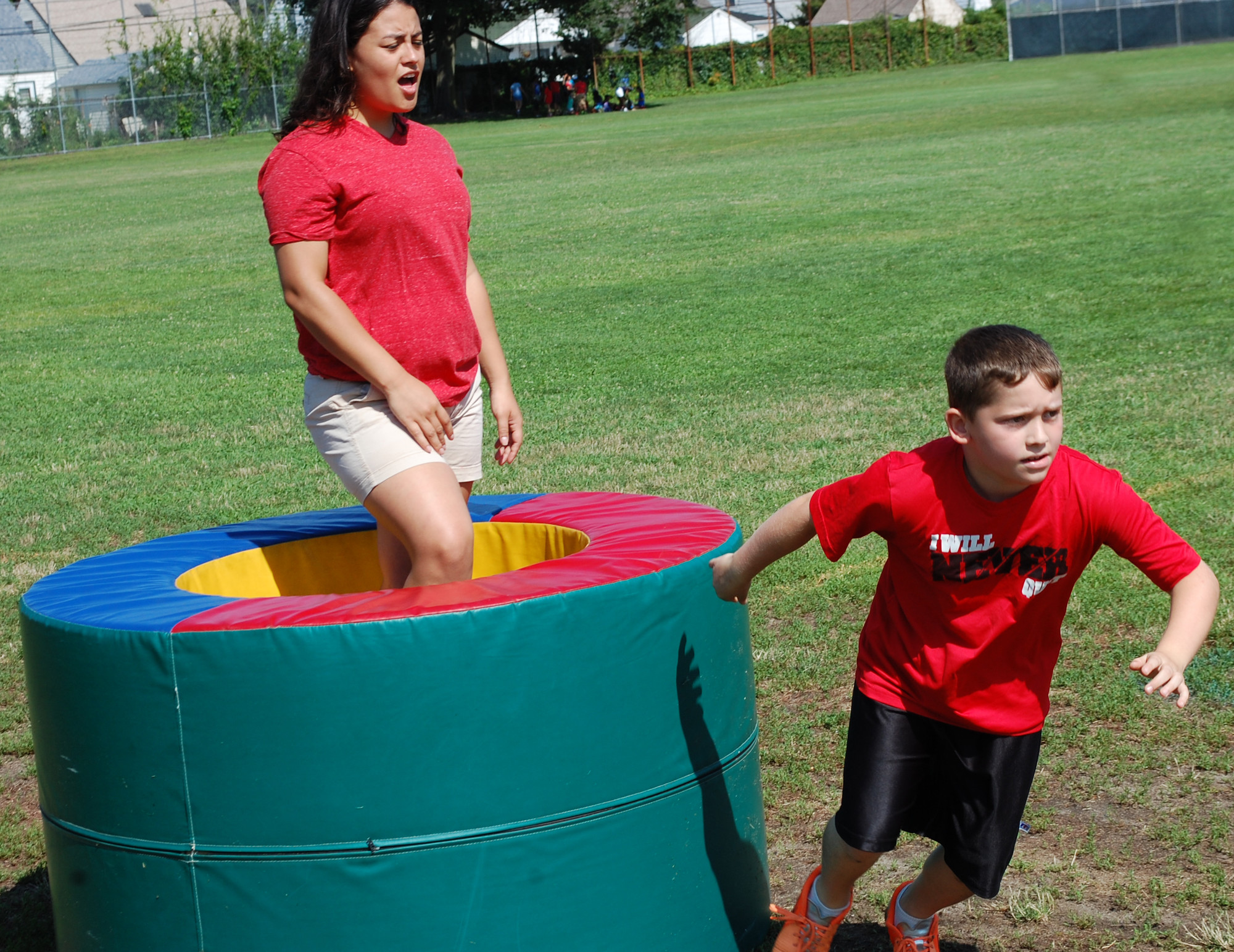 Christian Bolognese made the turn to head through the second leg of the obstacle course as counselor Brianna Fortiz cheered him on.