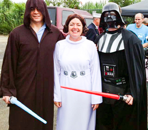 MaryKate Lynch, center, with Adam Harrison, left, and Josh Warner said the “force is with us” at the playground building event.
