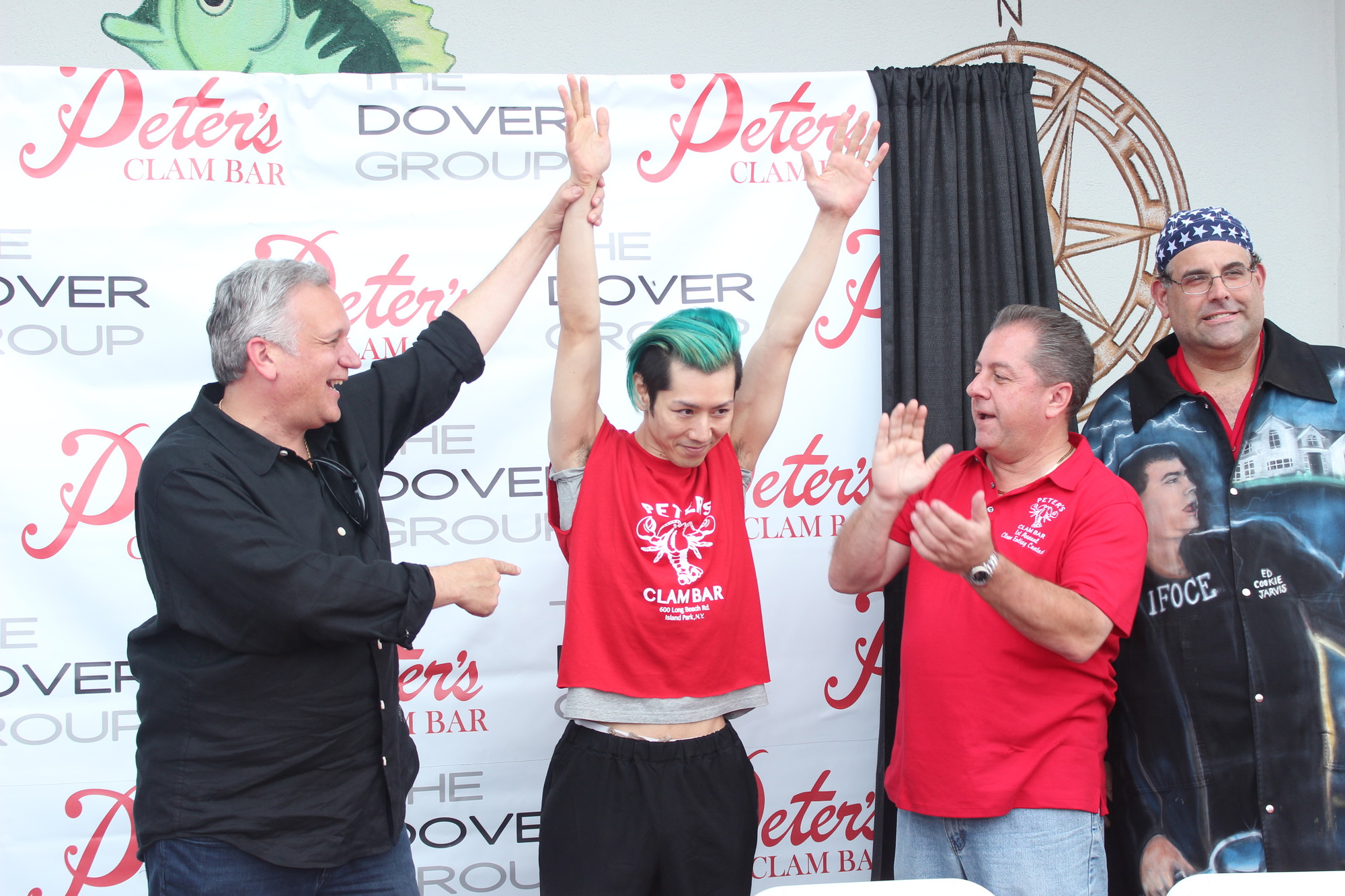 Nassau County Executive Ed Mangano, left, was on hand to welcome world eating champ Takeru Kobayashi to Peter’s Clam Bar 1st Annual Clam Eating Contest.  On right is owner Butch Yamali.