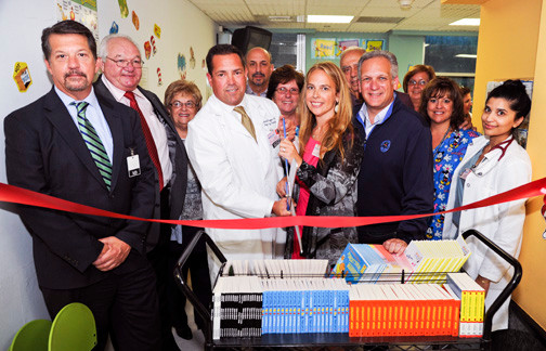 Nassau university medical center officials, joined by representatives from Nassau County and the East Meadow Chamber of Commerce, cut the ribbon for the hospital’s Reach Out and Read program on Aug. 13.