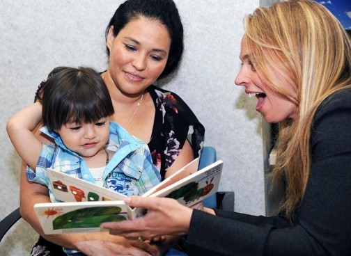 The Nassau University Medical Center launched a  new program last week in its pediatric ward to promote early literacy. Carlos Mejia Gonzalez, 23 months, and his mother, Lourdes, center, accepted a book from Dr. Dina Lieser, the hospital’s director of community pediatrics.