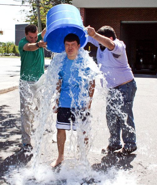 Herald intern Jimin Kim took an icy bath, with the help of editors Andrew Hackmack, left, and Alex Costello, to combat ALS, on Aug. 18.