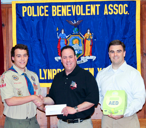 Lynbrook PBA Brian Palladino and Eagle Scout at St. James Church. Their project was to bring AEDs to the church.