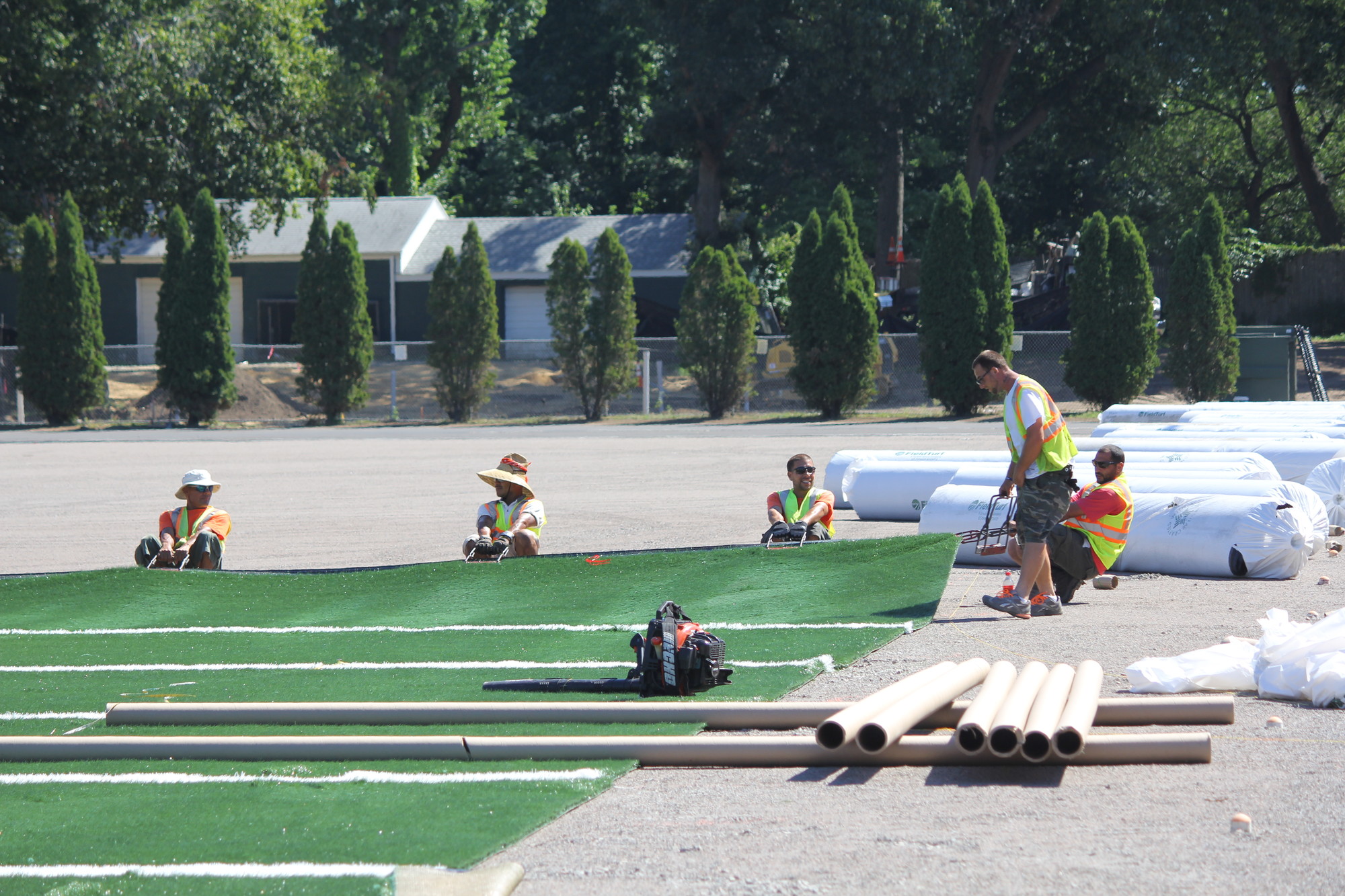 The synthetic turf field had to be rolled and stretched into place, much like a carpet.