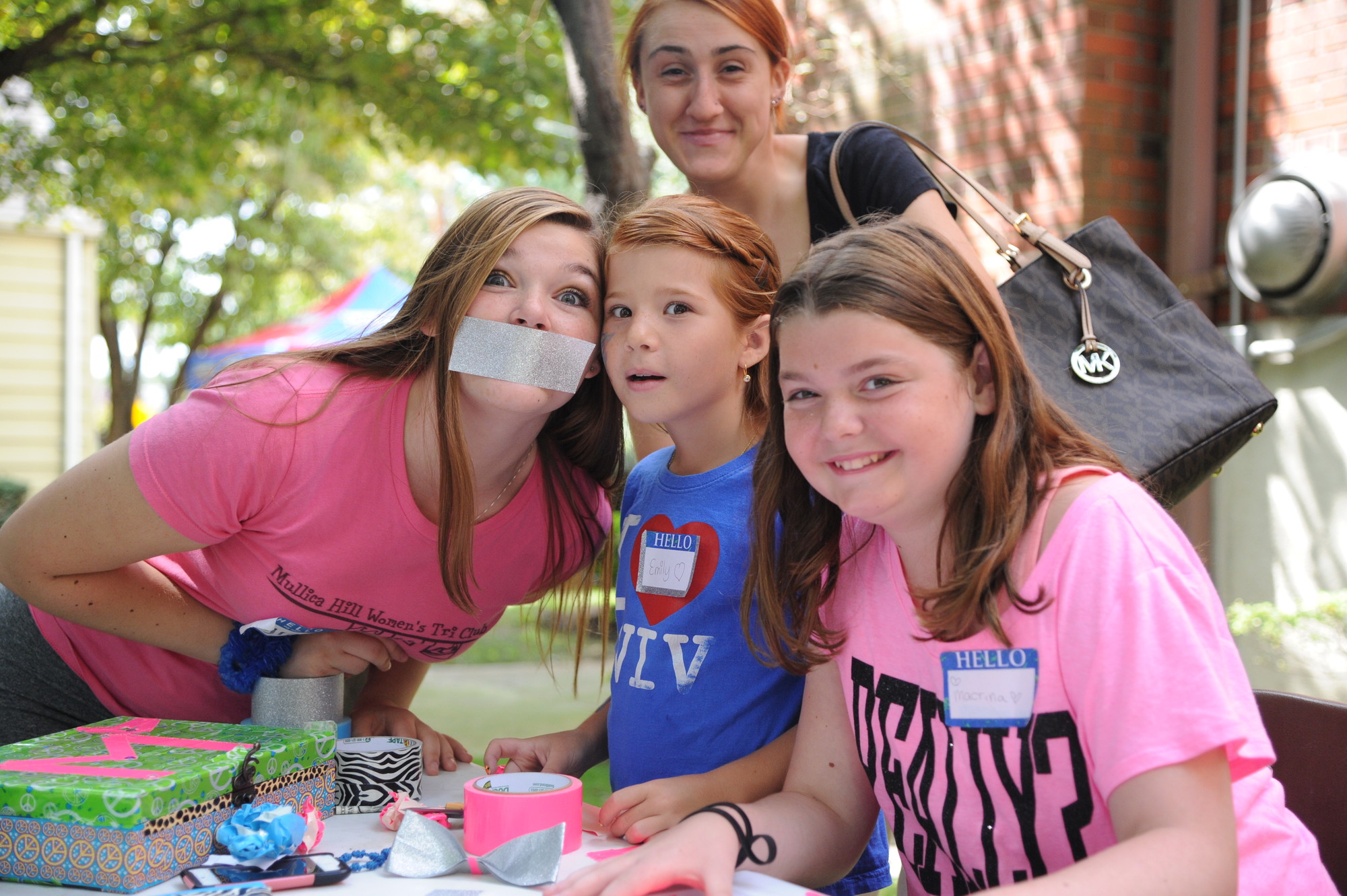 Kyra Kraus, 16, at left, Emily Cackett, 10, Macrina Kraus, 11, and Maria Krzeminski, 18, up top, dabbled in arts and crafts at the family festival.