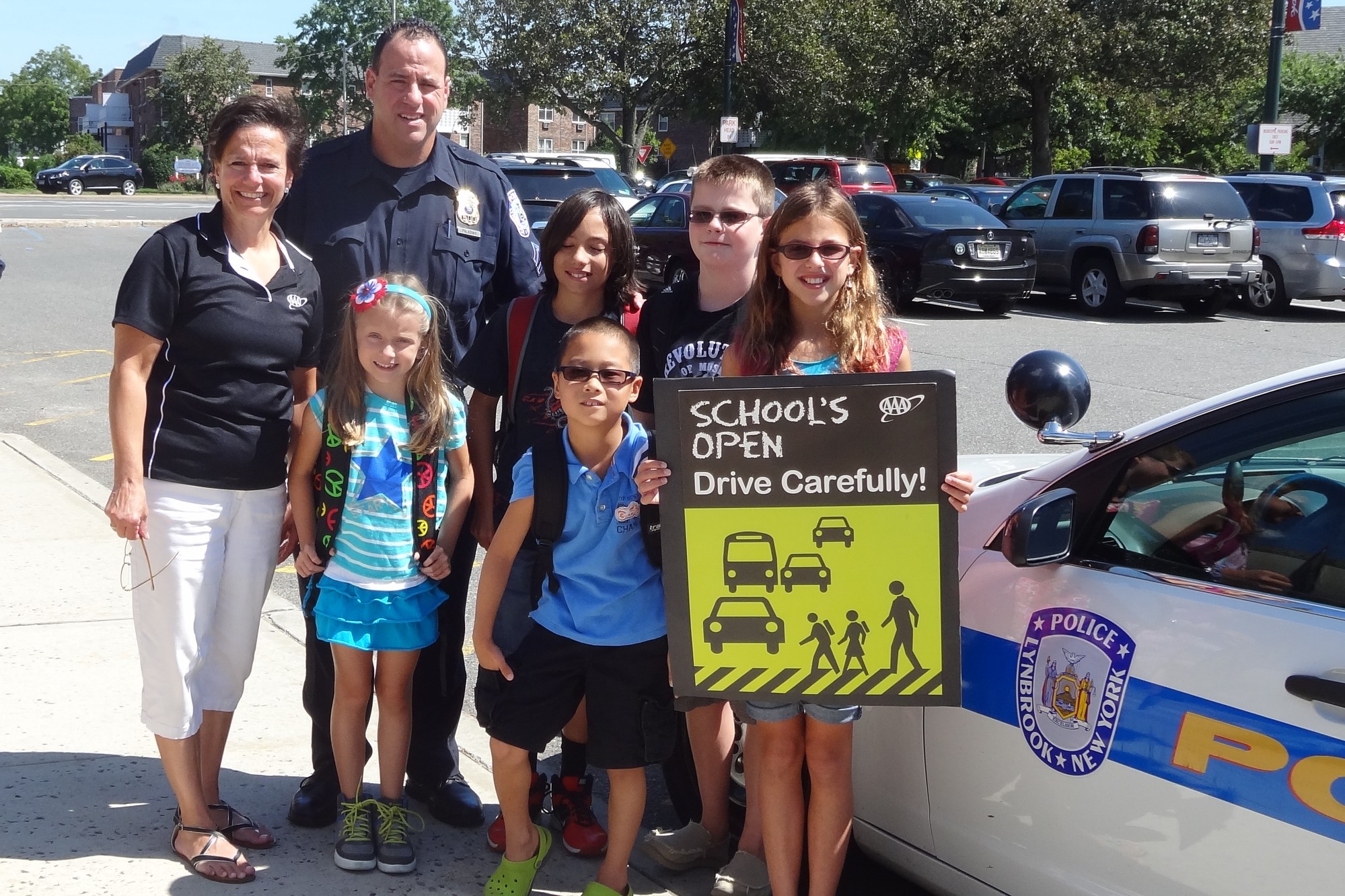 Sergeant Brian Paladino of the Lynbrook Police Department, along with AAA’s Traffic Safety Specialist Karen Blackburn, left, helped to launch AAA’s “School’s Open — Drive Carefully” campaign at police headquarters in Lynbrook. Also pictured were students Marisa Parco, Jimmy Pardo, Chris Paladino, Nicholas Paladino and Emmie Paladino.
