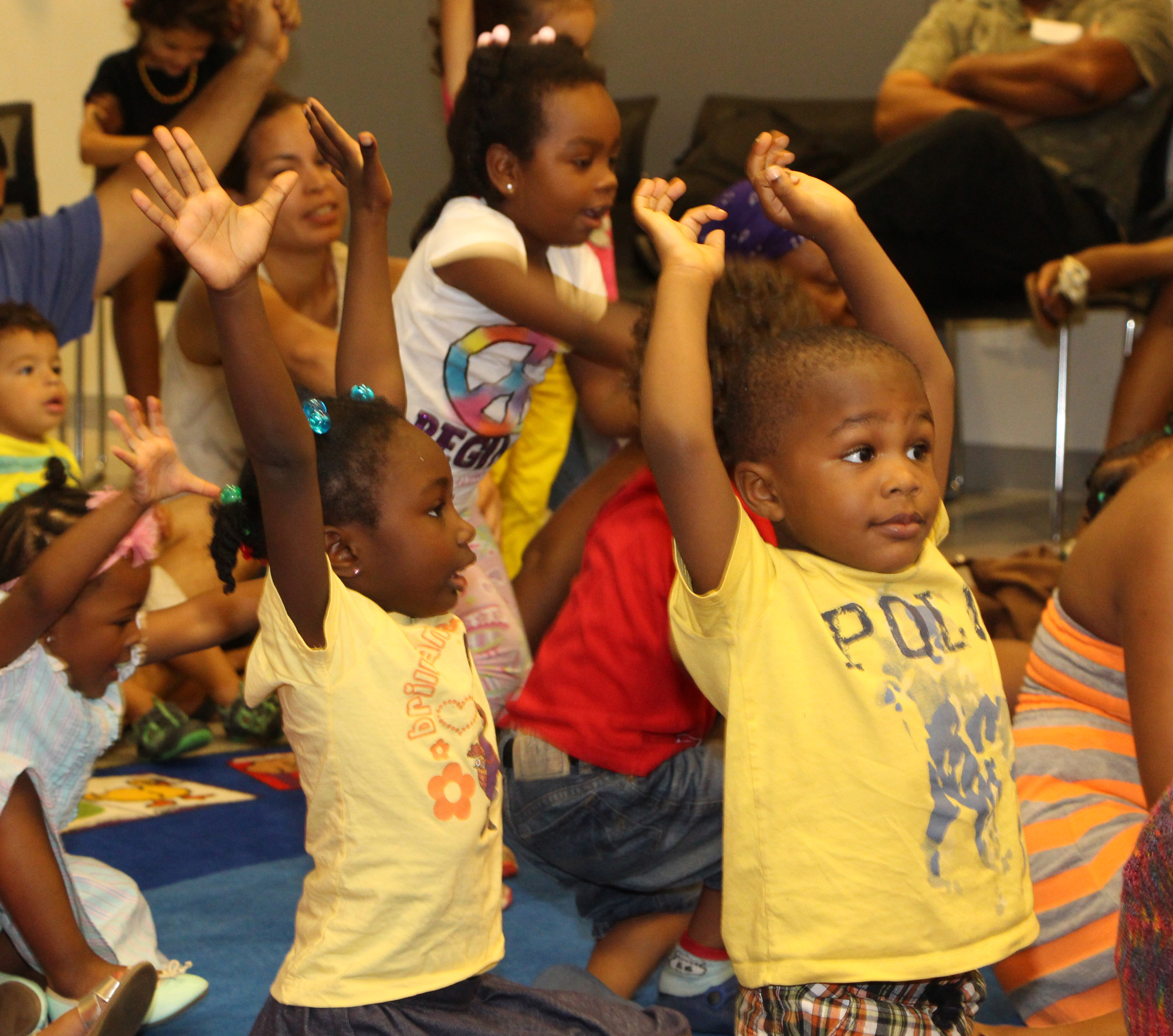 Enitan Collins, 4, right, and Anike Collins, 3, danced, swung their arms and swayed to the Turtle Dance Music. with their friends from the Read-To-Me Club.