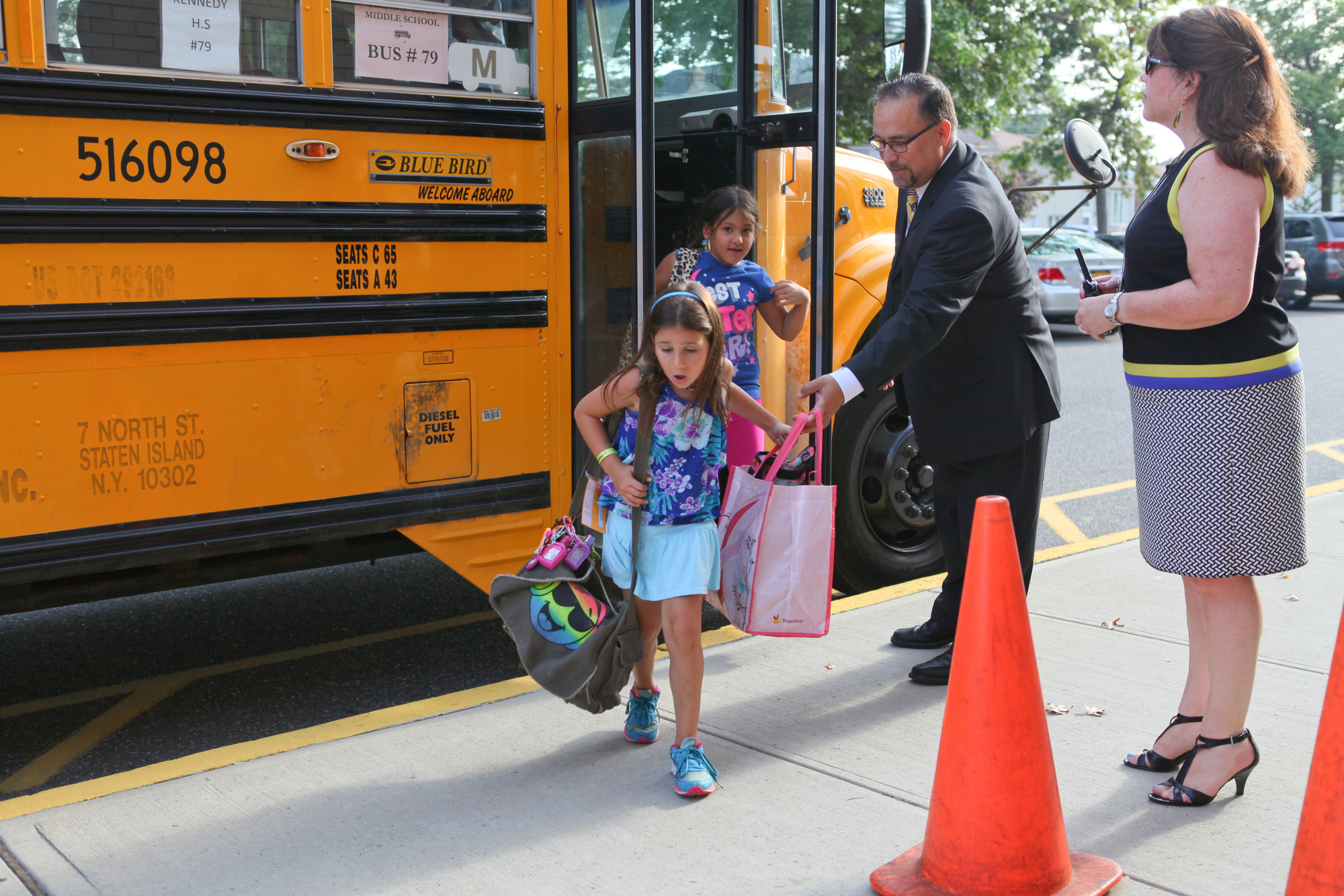 Bellmore Superintendent Dr. Joseph Famularo and Principal Patti Castine assisted children off the bus at the Reinhard center.