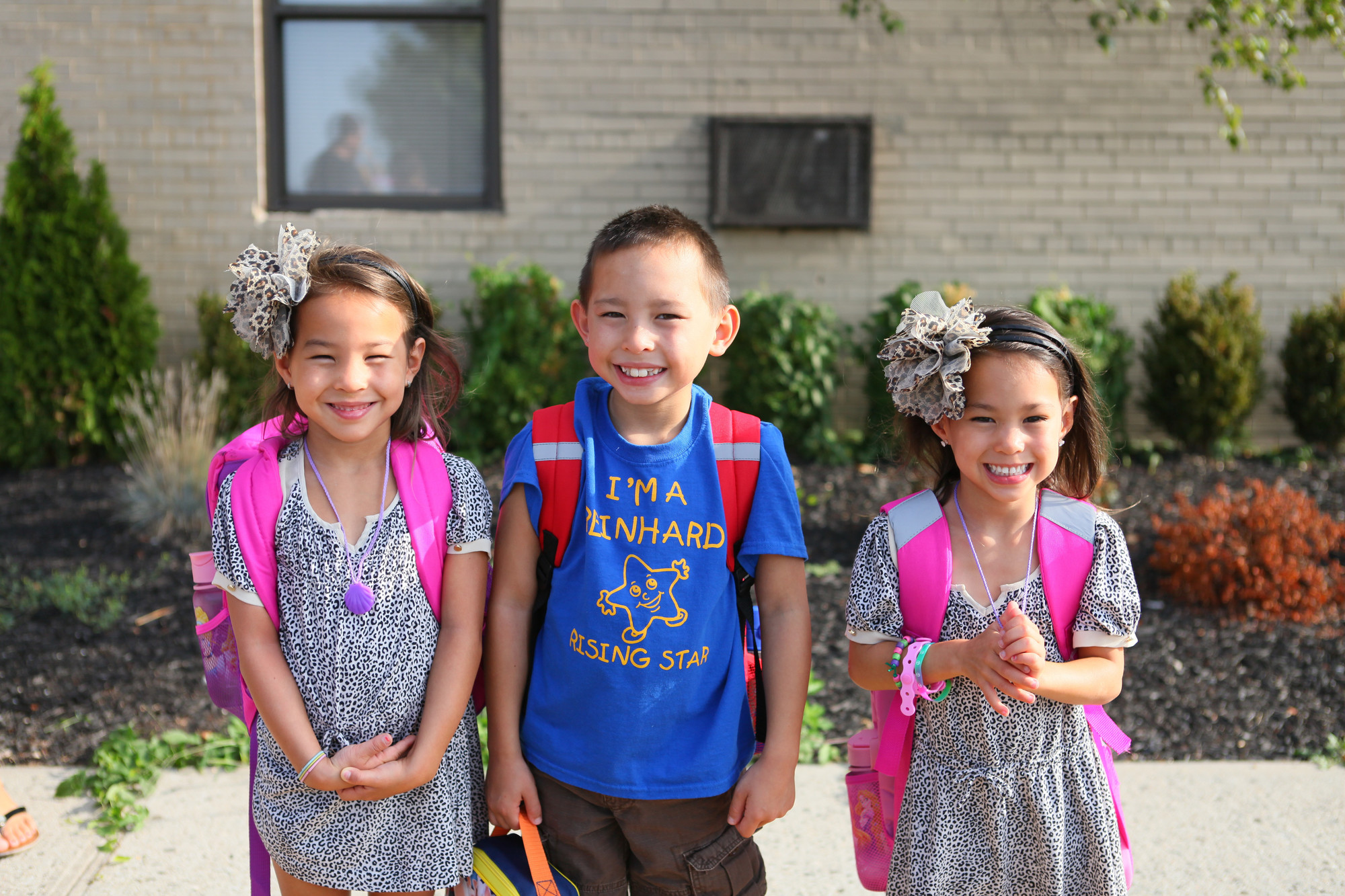 The Flynns –– kindergartner Colleen, second-grader Michael and kindergartner Caeley –– arrived at the Charles Reinhard Early Childhood Center in Bellmore on Tuesday.
