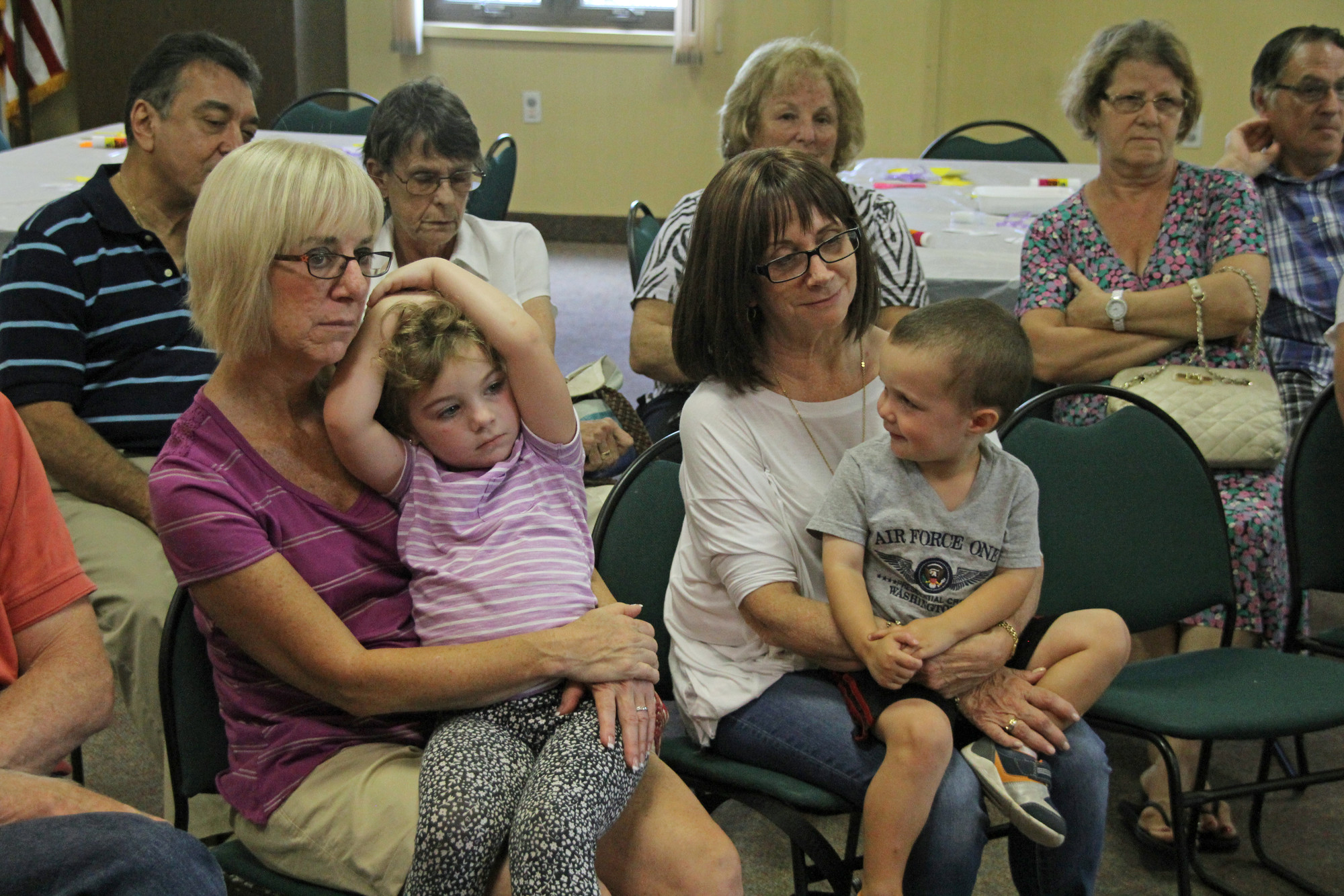 Jen Kushnick and Eileen Lutwick, from left, listened to stories with their respective grandchildren, 4-year-old Ellis Caplinger and 3-year-old Matthew Lutwick.