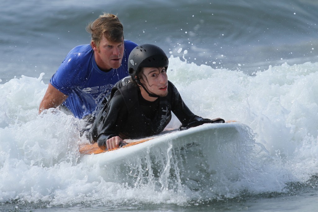 Dylan Hronec, front, a 22-year-old Bellmorite who has cerebral palsy, has surfed since 2012. At right, he was joined 
recently by Surf For All Co-founder Cliff Skudin.