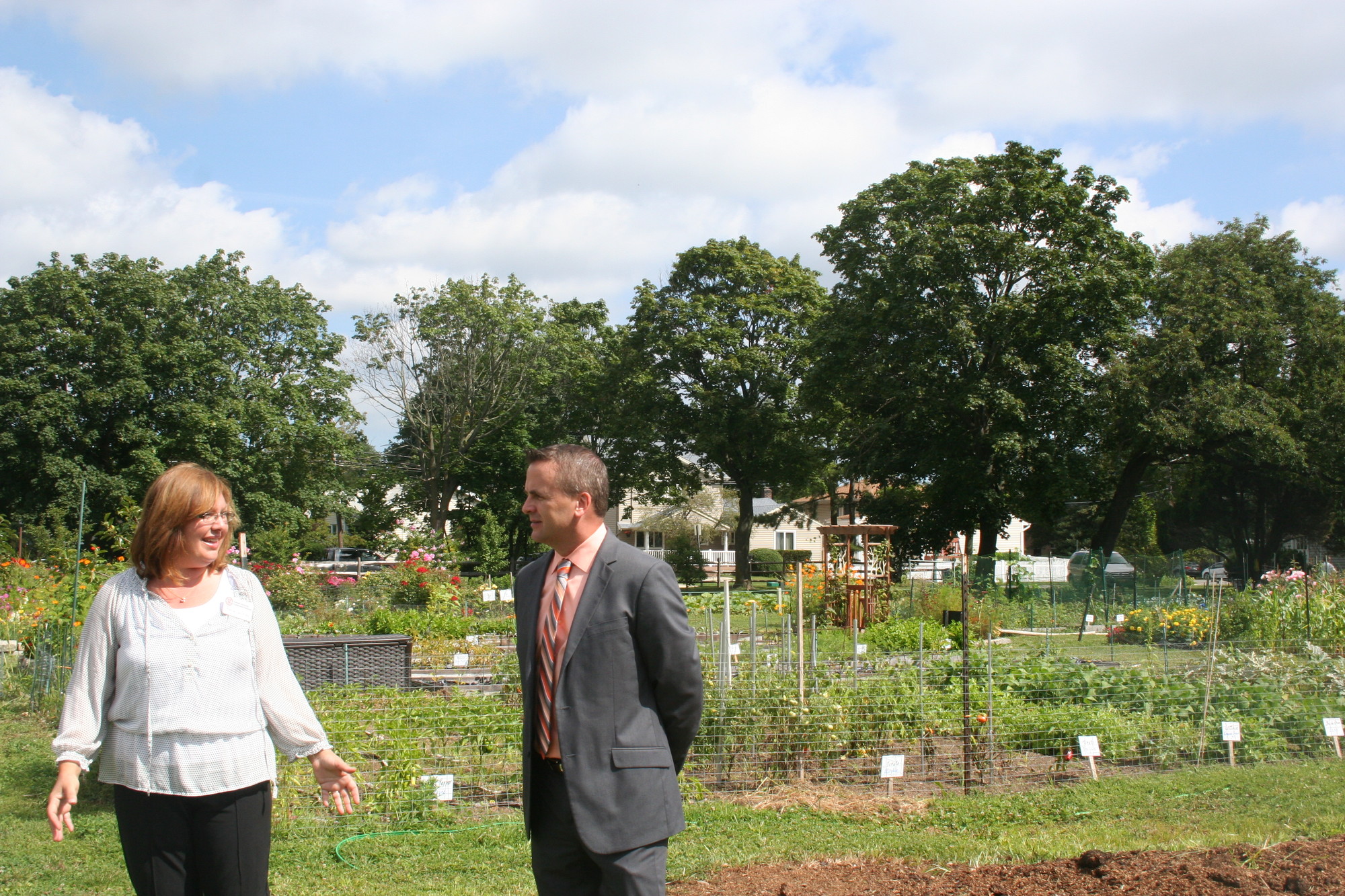 Cornell Cooperative Extension Horticulturist and Community Educator Bonnie Klein described the purpose of each garden to New York American Water Vice President of Operations Brian Bruce at the East Meadow Farm. NYAW donated $5,000 to CCE for its initiative to grow native plants.