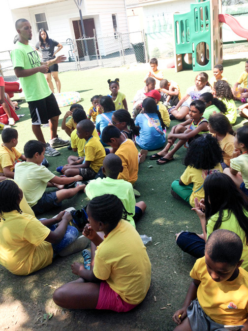 A staff member speaks to campers