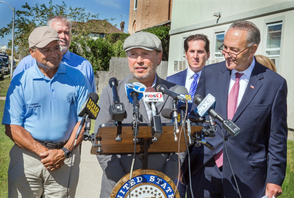 Actor Billy Crystal, center, and U.S. Sen. Charles Schumer, right, were joined by city officials at a press conference on Monday, where they called on FEMA and HUD to cover the city's costs of removing and replacing trees destroyed by Hurricane Sandy.