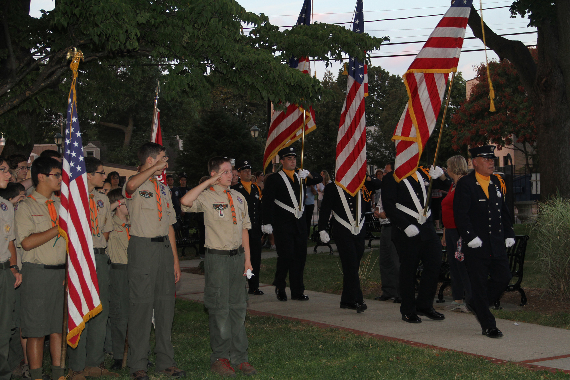 The annual ceremony brings local community groups and organizations together, like the East Meadow Fire Department, right, and Boy Scouts, at left.