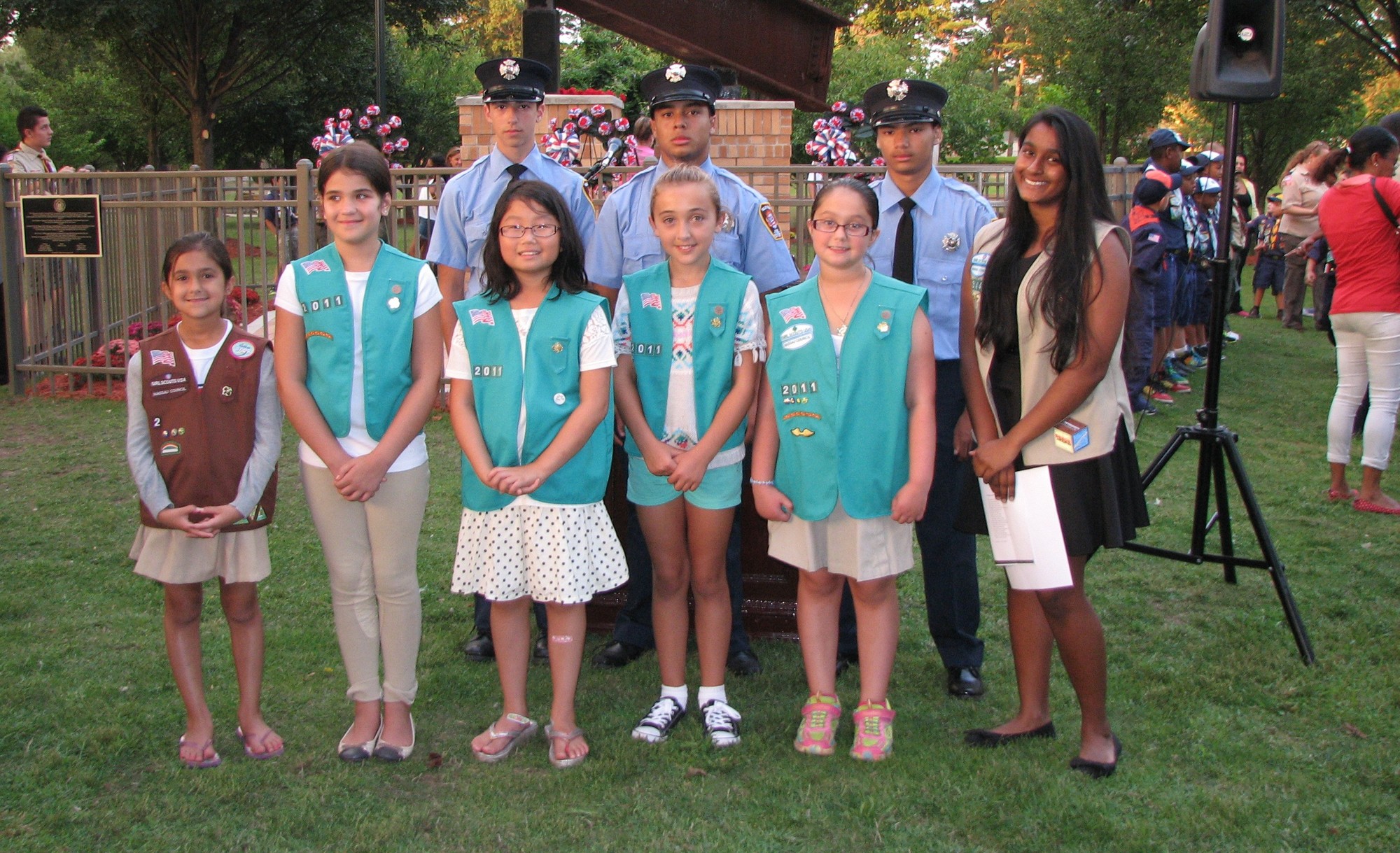 Girl scouts, front, and members of the Valley Stream Junior Fire Department, rearm with Sarah Azeez, at right