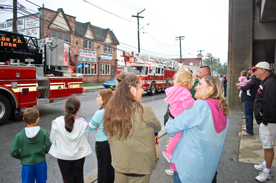 The crowd watched Wantagh fire trucks roll by along Railroad Avenue.
