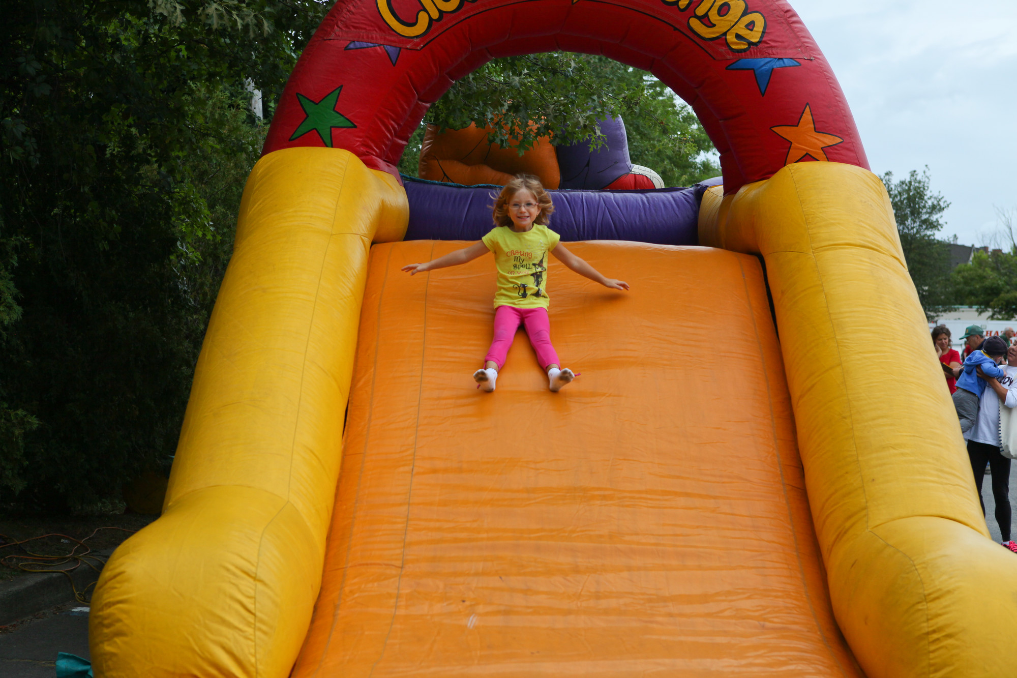 Anna Demos, 4, smiled as she slid down one of the inflatable at the Kids Fest at the Rockville Centre Recreation Center.